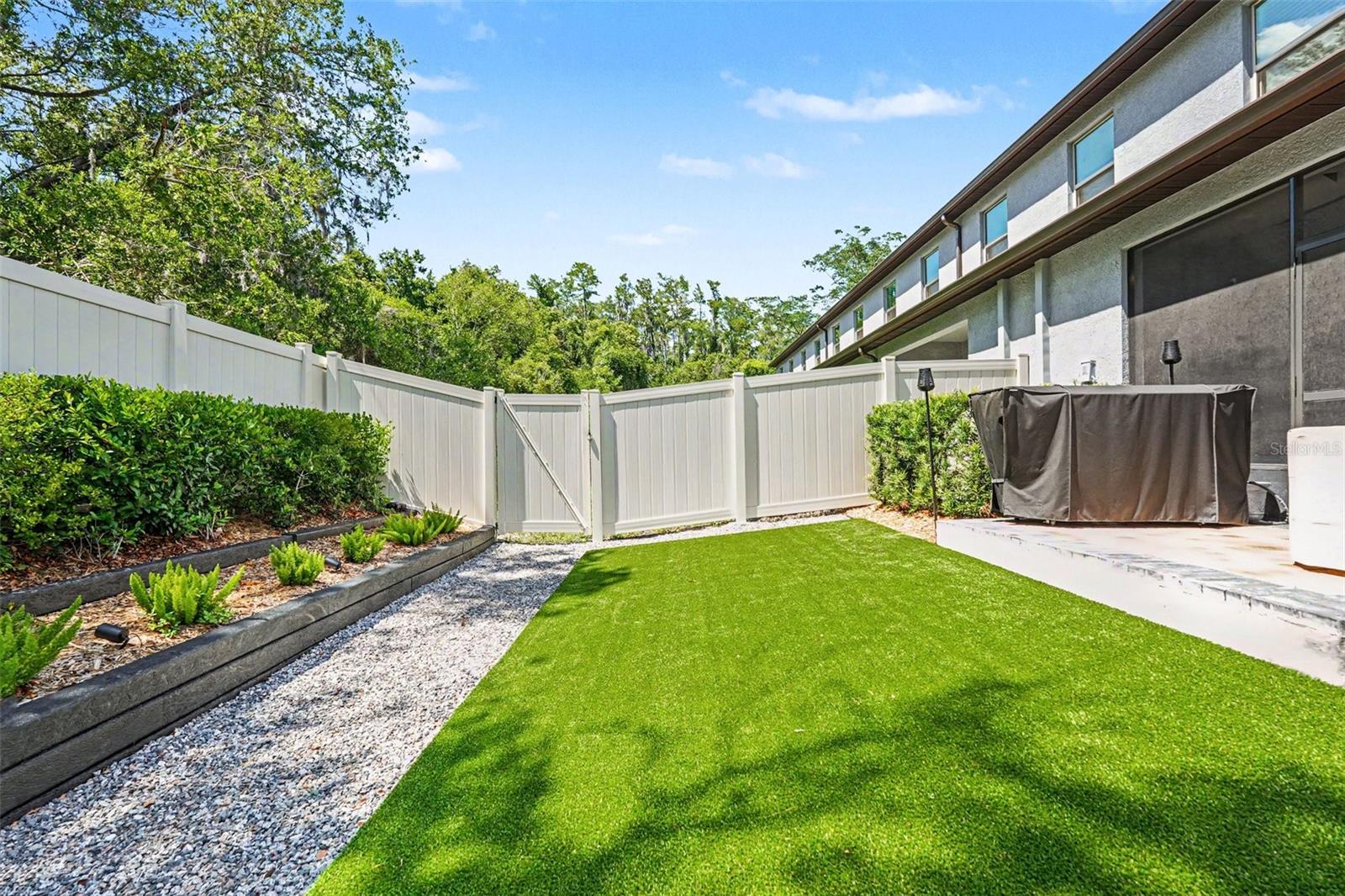 Backyard-Artificial-Turf-Low-Maintenance-Landscaping-Raised-Beds-Holiday-FL