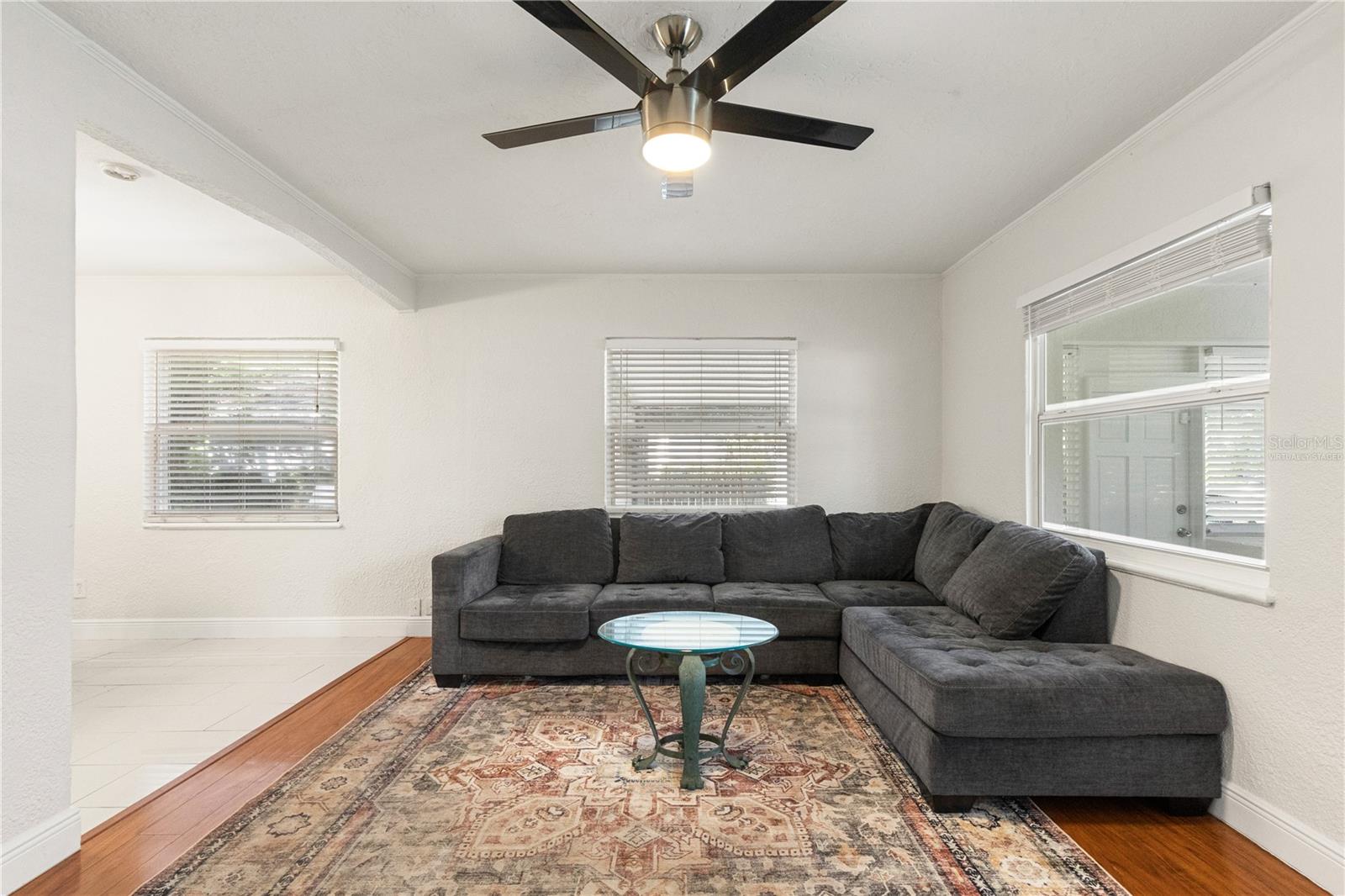 Living room (virtually staged) open to kitchen