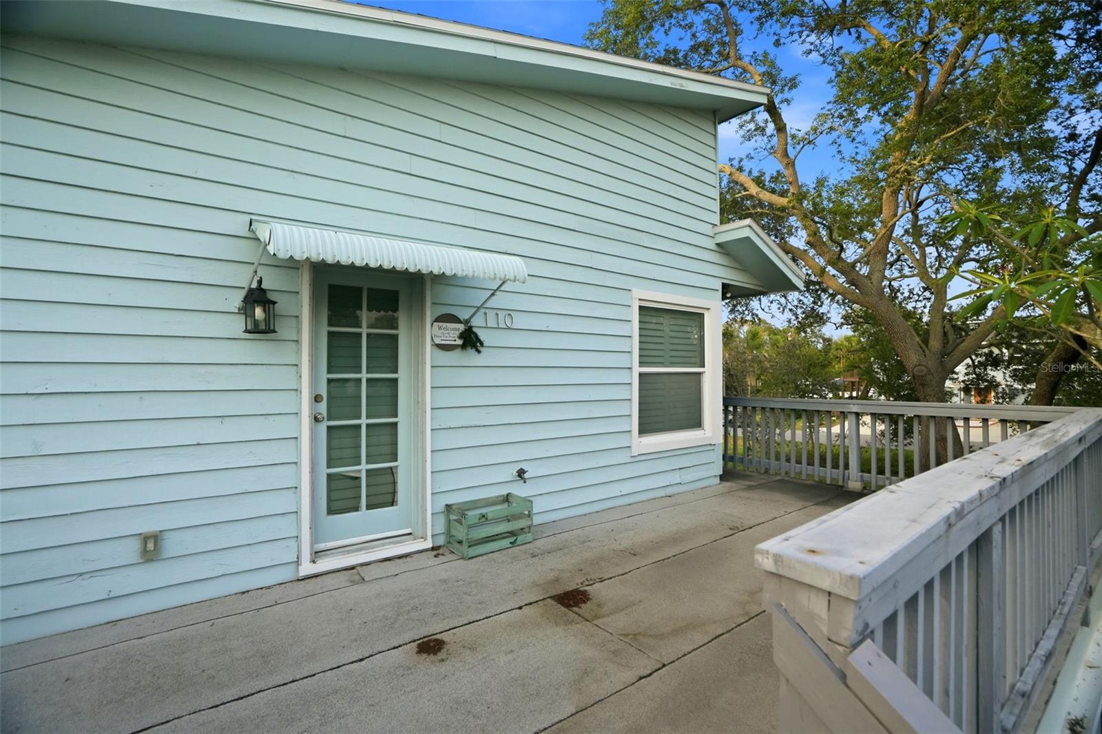 The Key West style home is elevated with decking around the entire home.