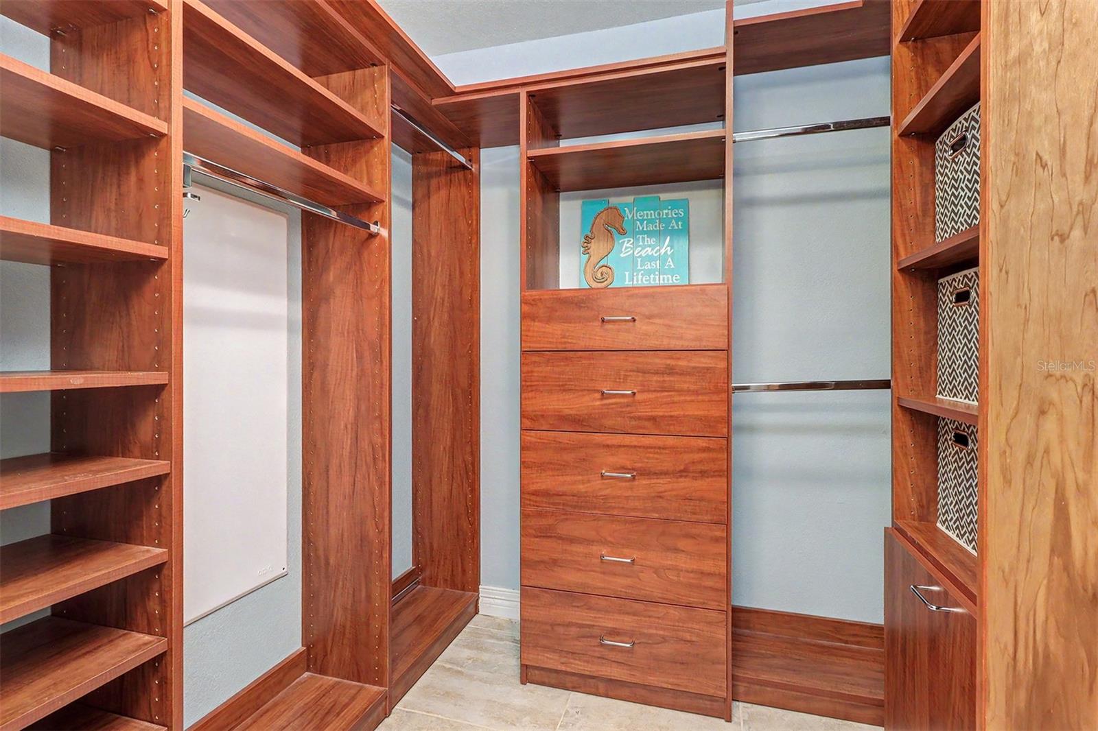 Custom-designed closet systems in all rooms maximize organization throughout the residence. The Primary Suite's walk-in closet offers premium built-ins, including a convenient hamper and a variety of thoughtfully designed storage options.