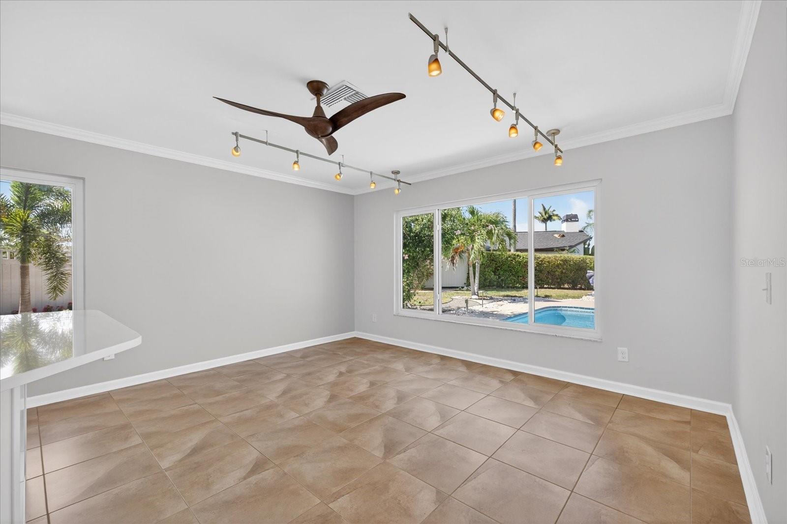 Breakfast nook/Dining area with gorgeous pool and water views.