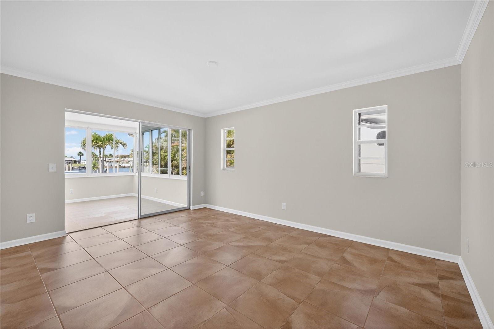 Primary bedroom with access to Florida Room and water views.