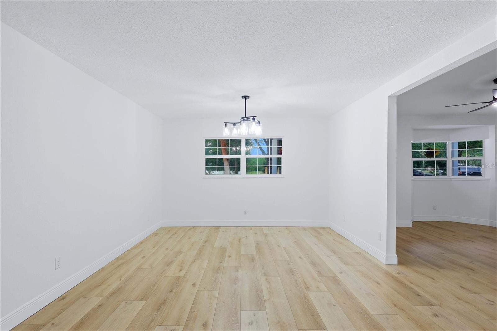 Dining room situated just off the living room and kitchen features a modern light fixture