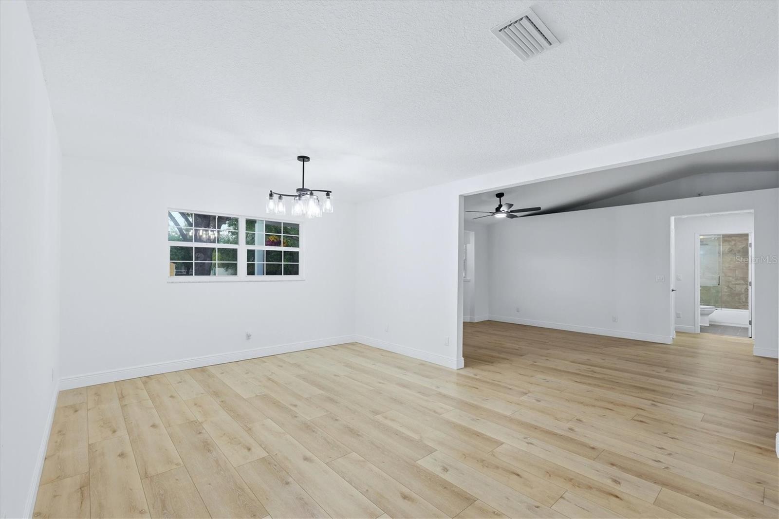 From dining area looking into living room and the hallway to the second bath that is located between two bedrooms
