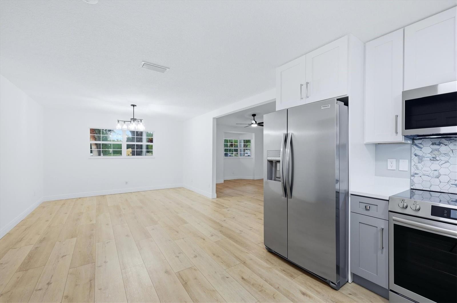 View from kitchen to dining area and front entry