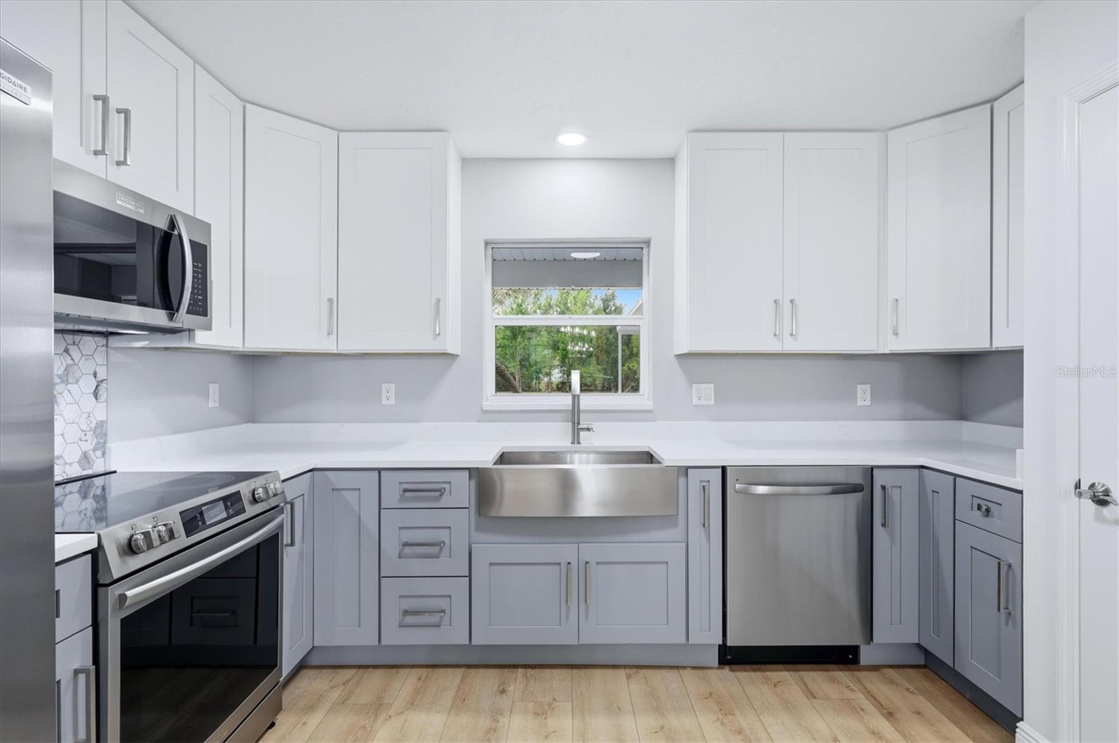 High quality wood cabinets & drawers with soft close feature accented with modern hardware and coordinating stainless-steel appliances.