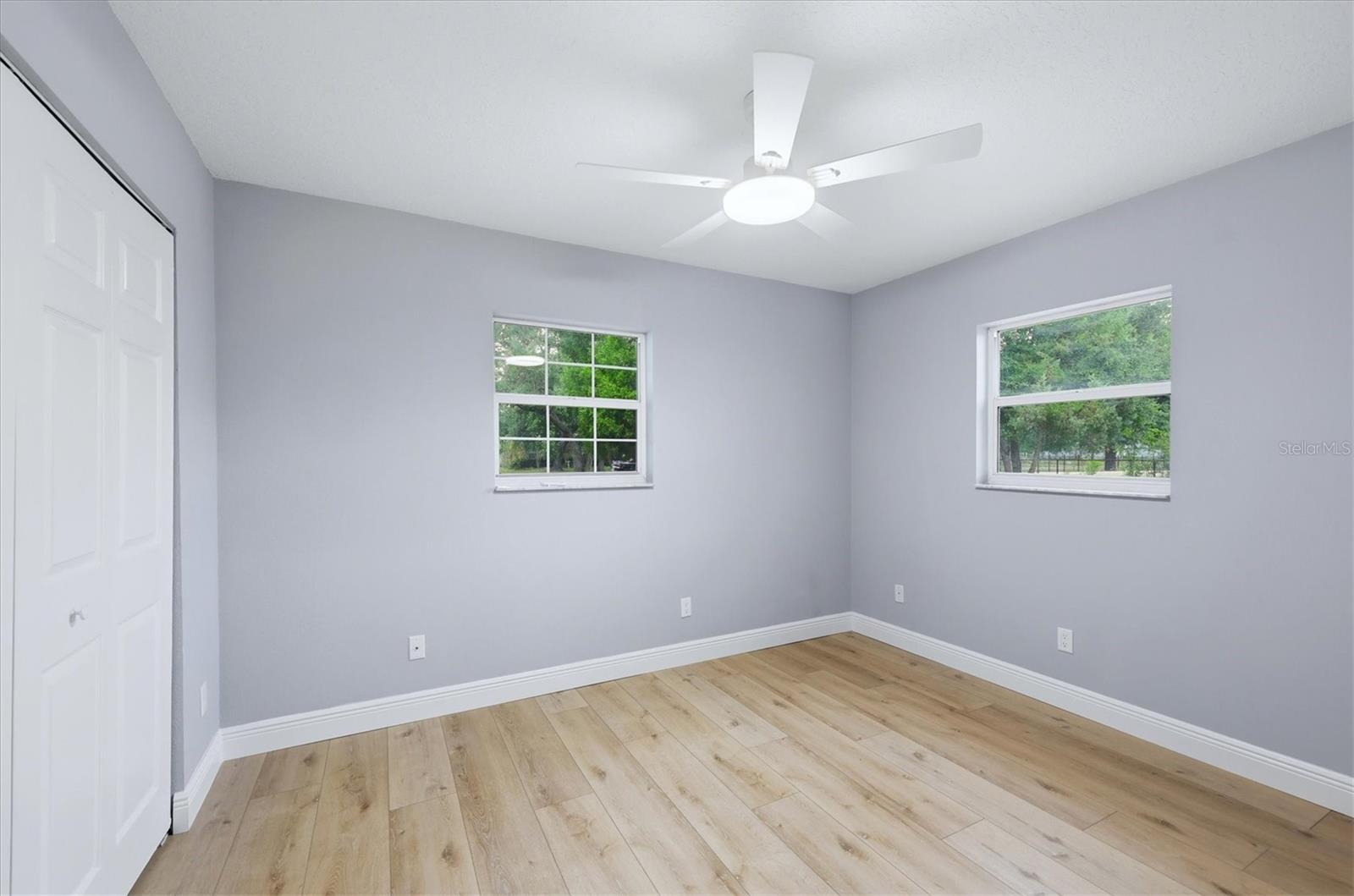 Secondary bedroom with ceiling fan controlled by remote and programable to day light, night light etc.
