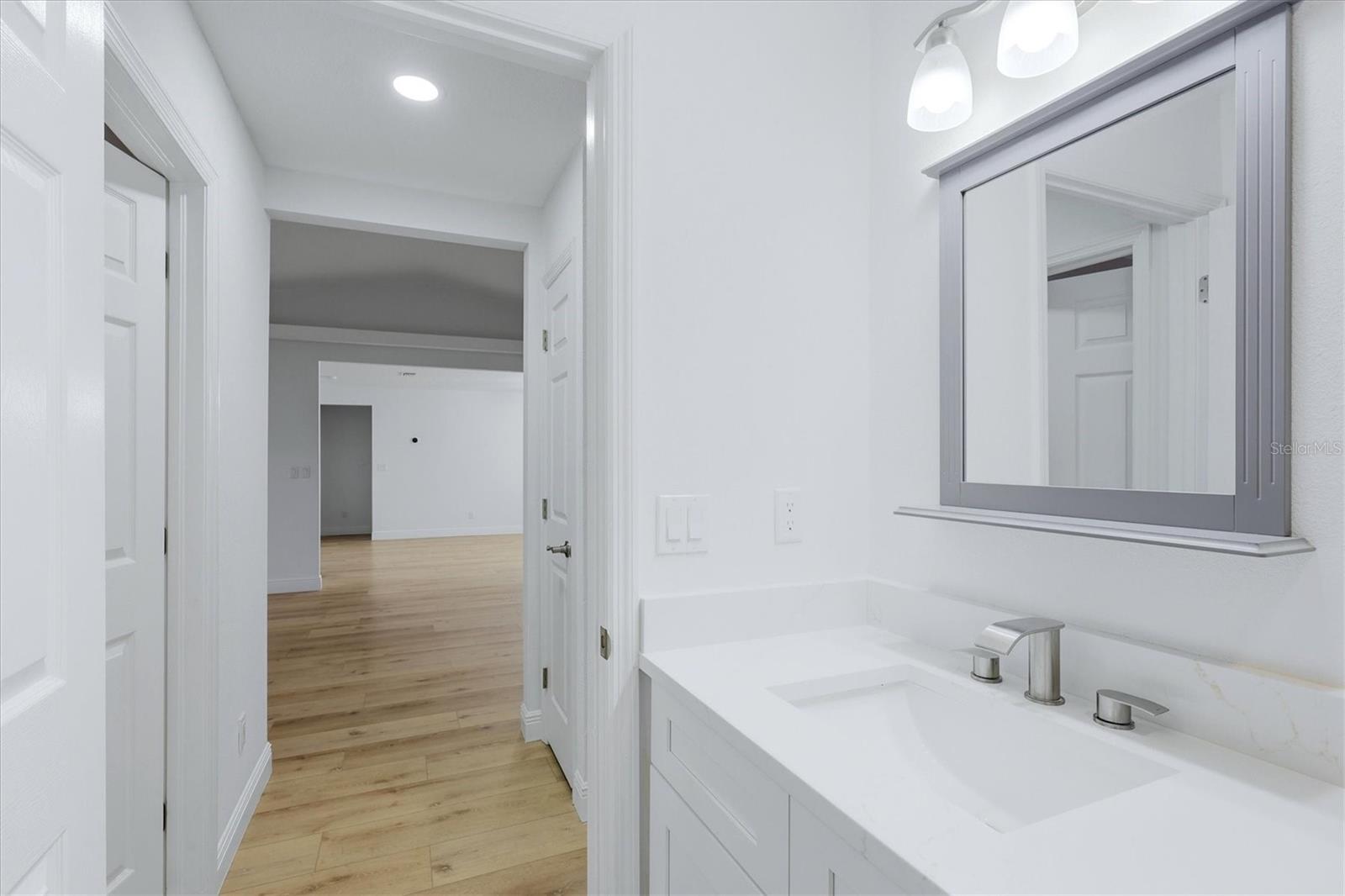 Secondary bath looking into hallway with linen closet before going into living room then dining room