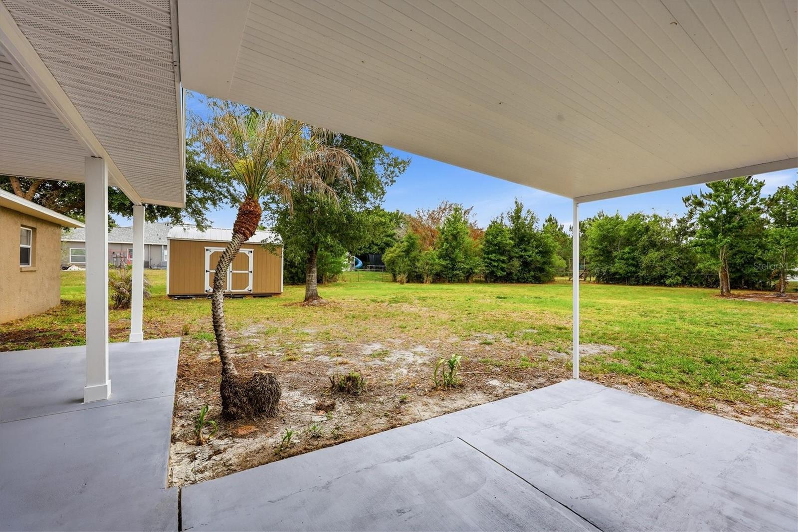 Back patio outside Primary suite and bonus room faces south and is covered by a flat roof.
