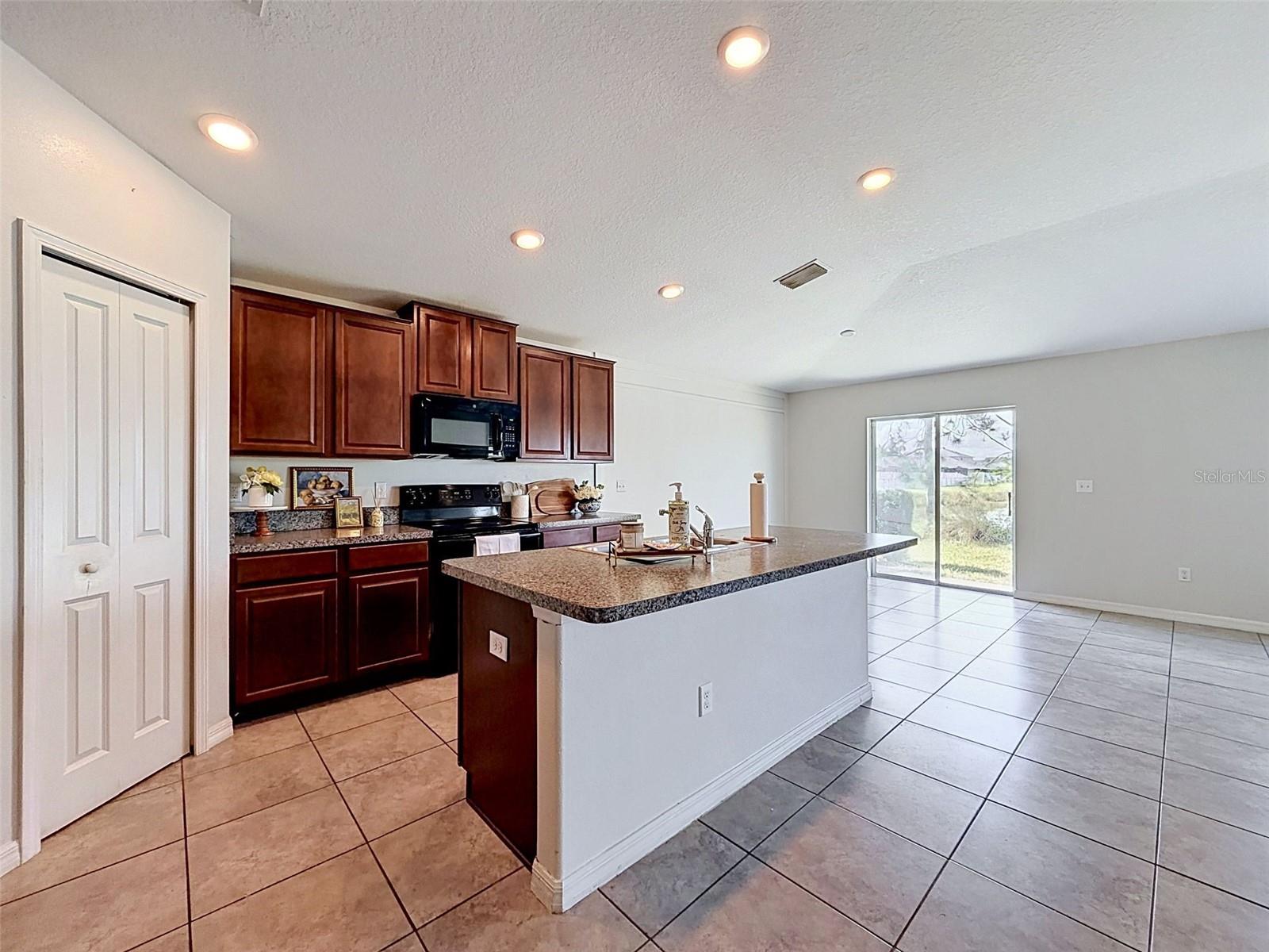 BIG, well-lit kitchen. Open to gathering spaces.