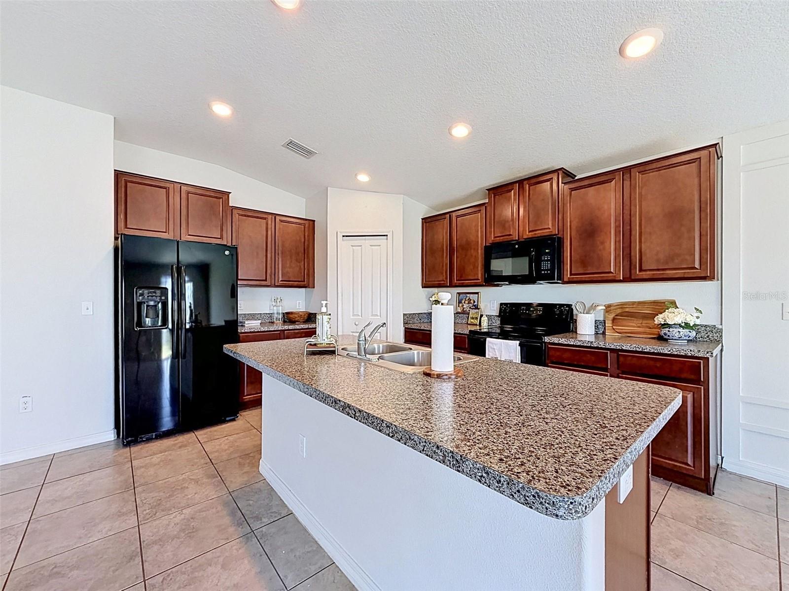 BIG, well-lit kitchen. Open to gathering spaces.