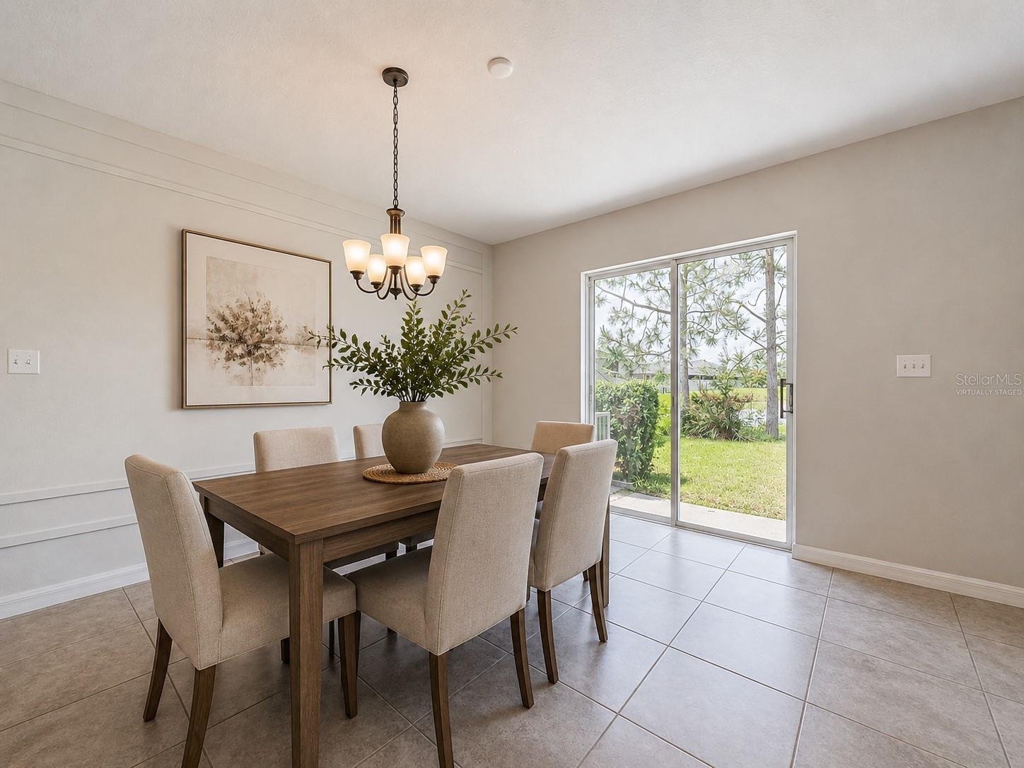 Virtually staged dining room facing the backyard.
