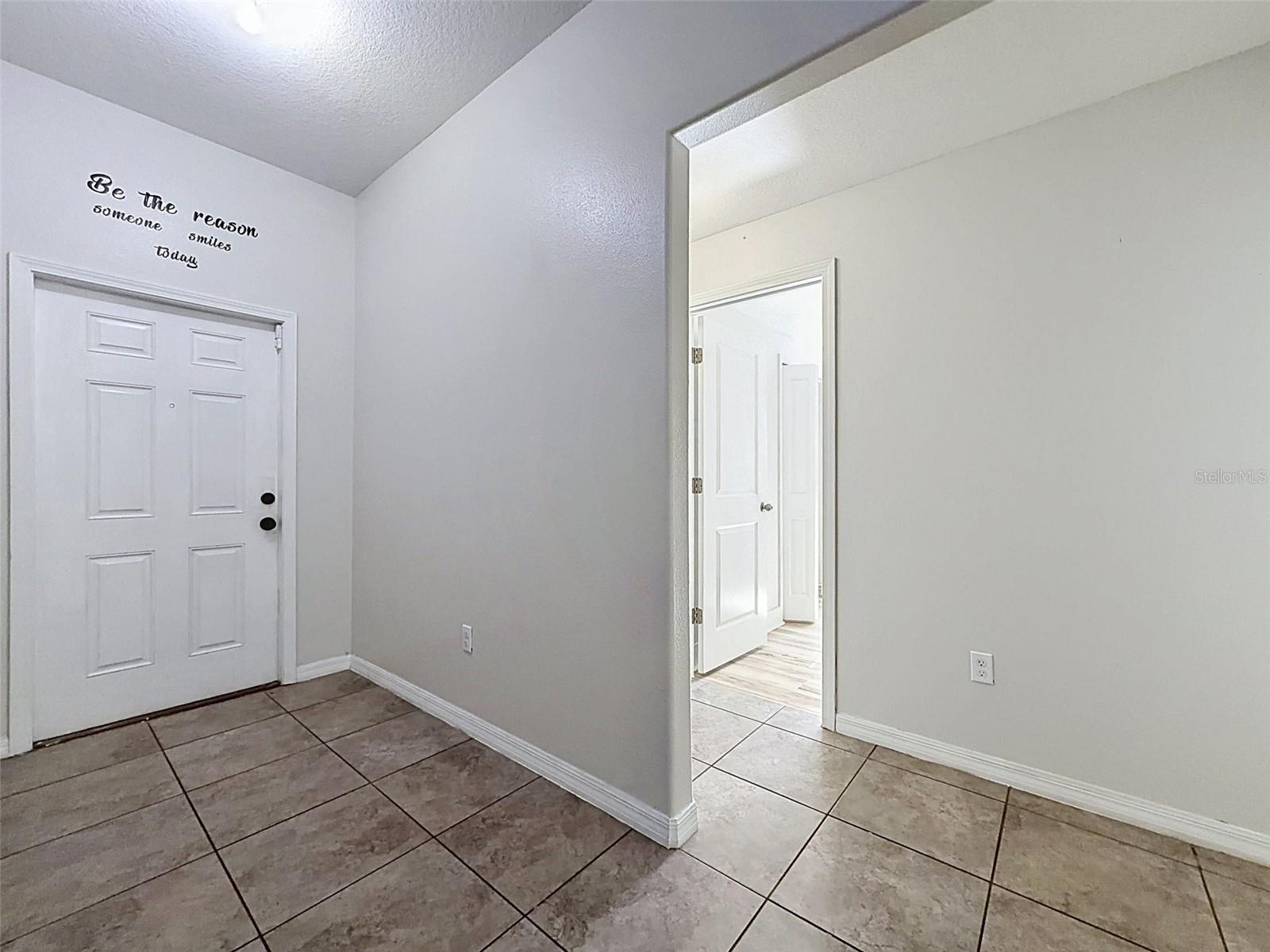 Foyer leading to three bedrooms and guest bath.