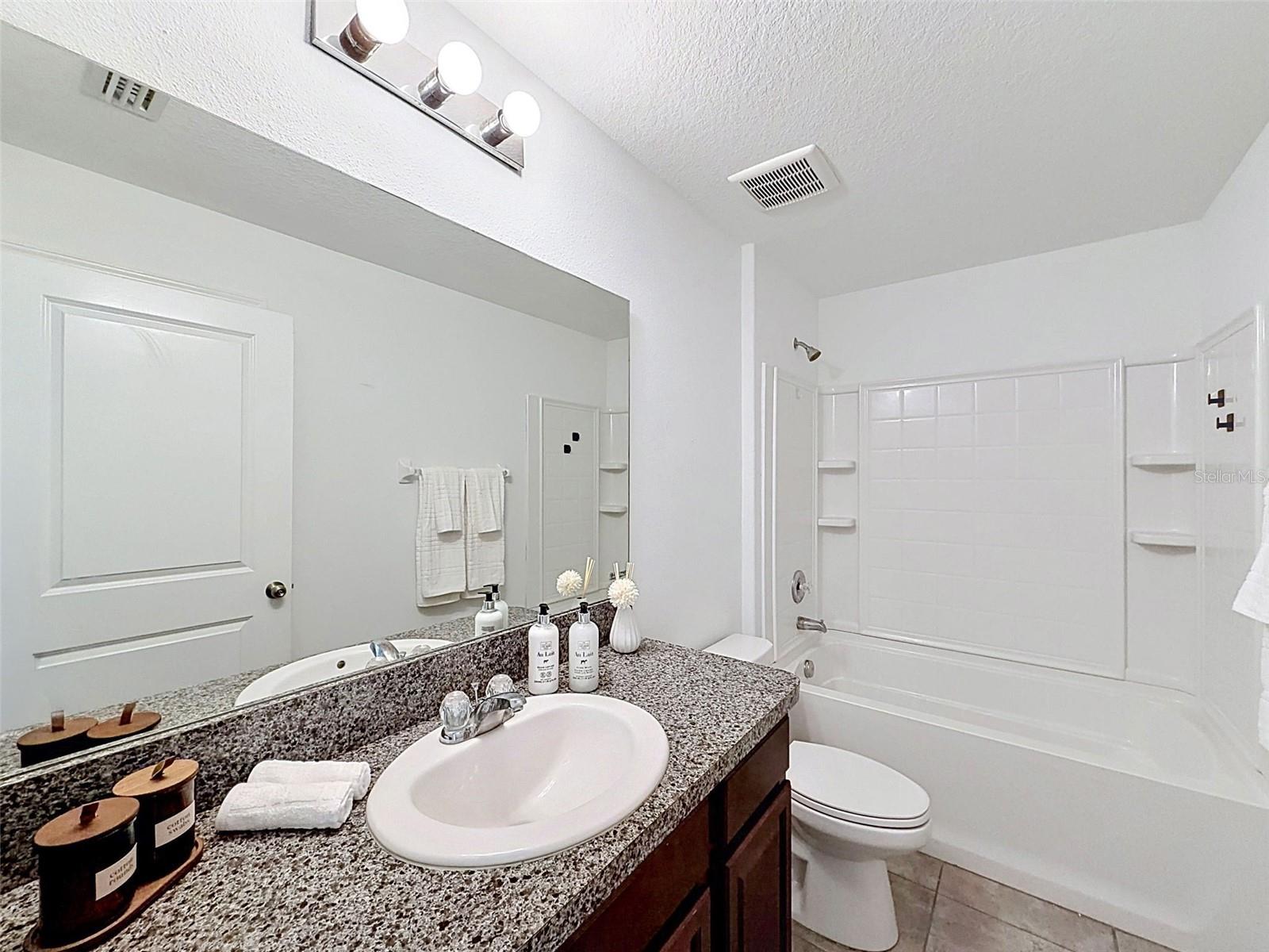 Hall (guest) bathroom. Linen closet behind the door!