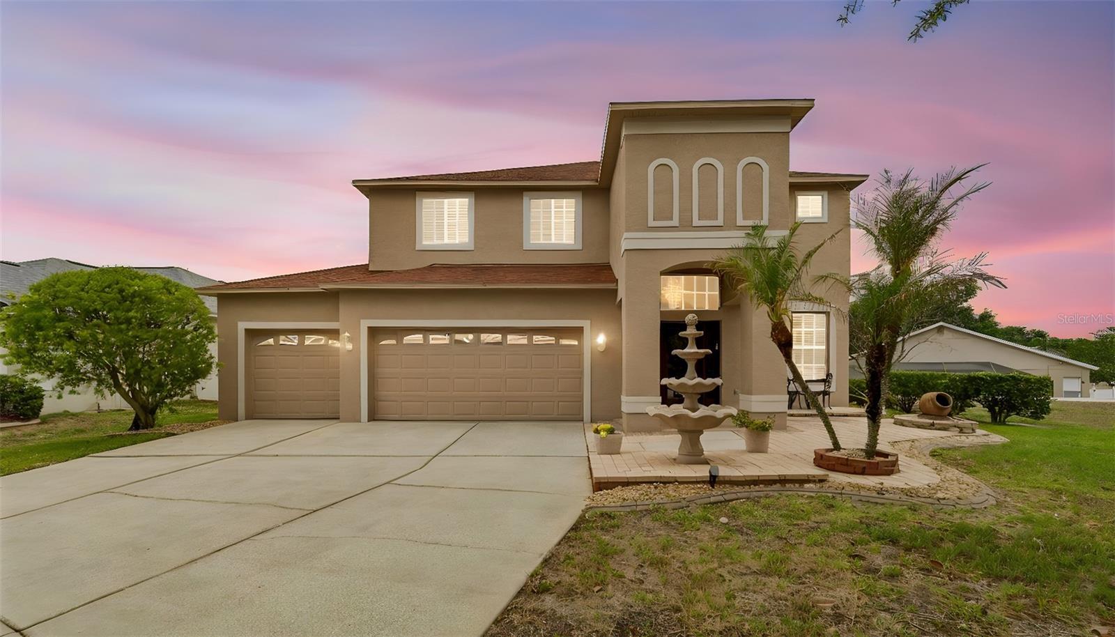 Home is distinguished by the welcoming Courtyard retreat, window trim, 3 tier water fountain, Mature Magnolia Tree and Robellini Palm.