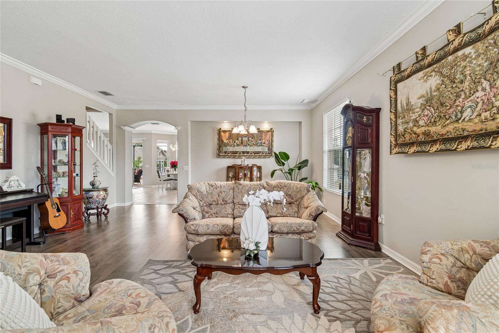 Open Living and Dining Area featuring crown molding