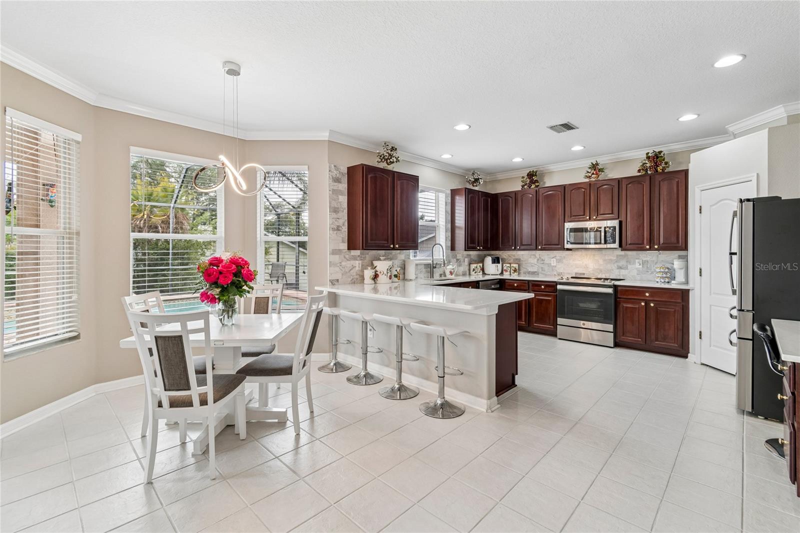 The Bay window in the kitchen eating area brings in even more natural light, overlooking the pool.