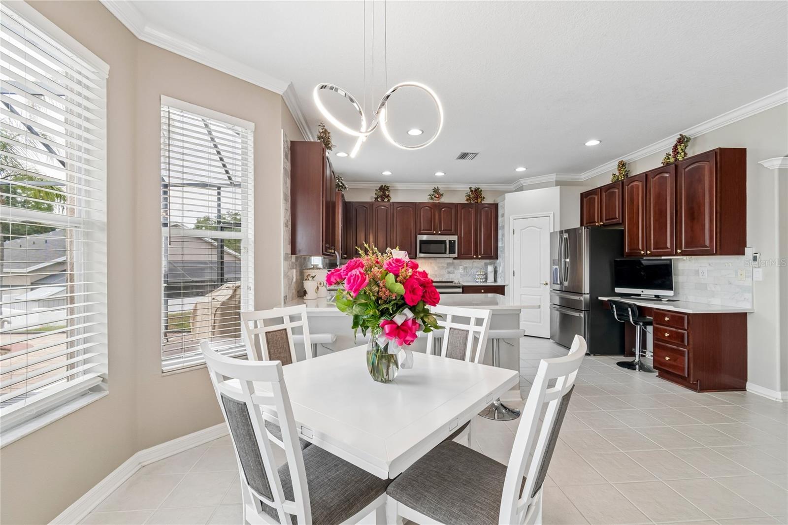 The Bay window in the kitchen eating area brings in even more natural light, overlooking the pool.