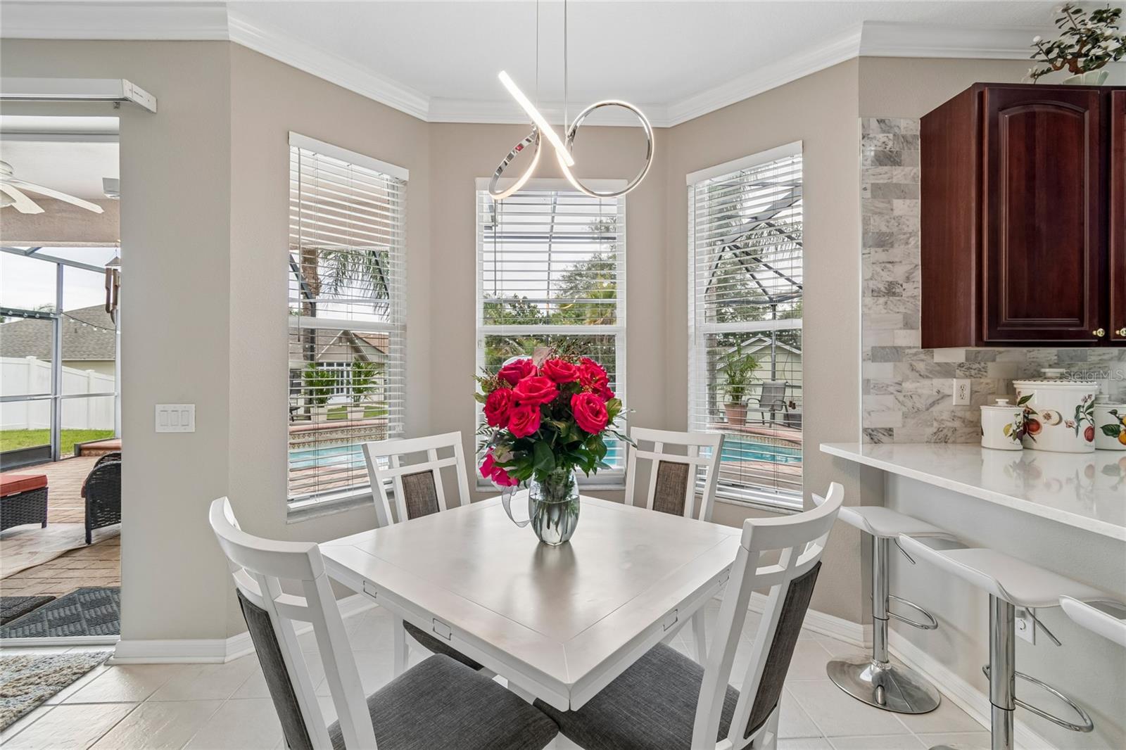 The Bay window in the kitchen eating area brings in even more natural light, overlooking the pool.