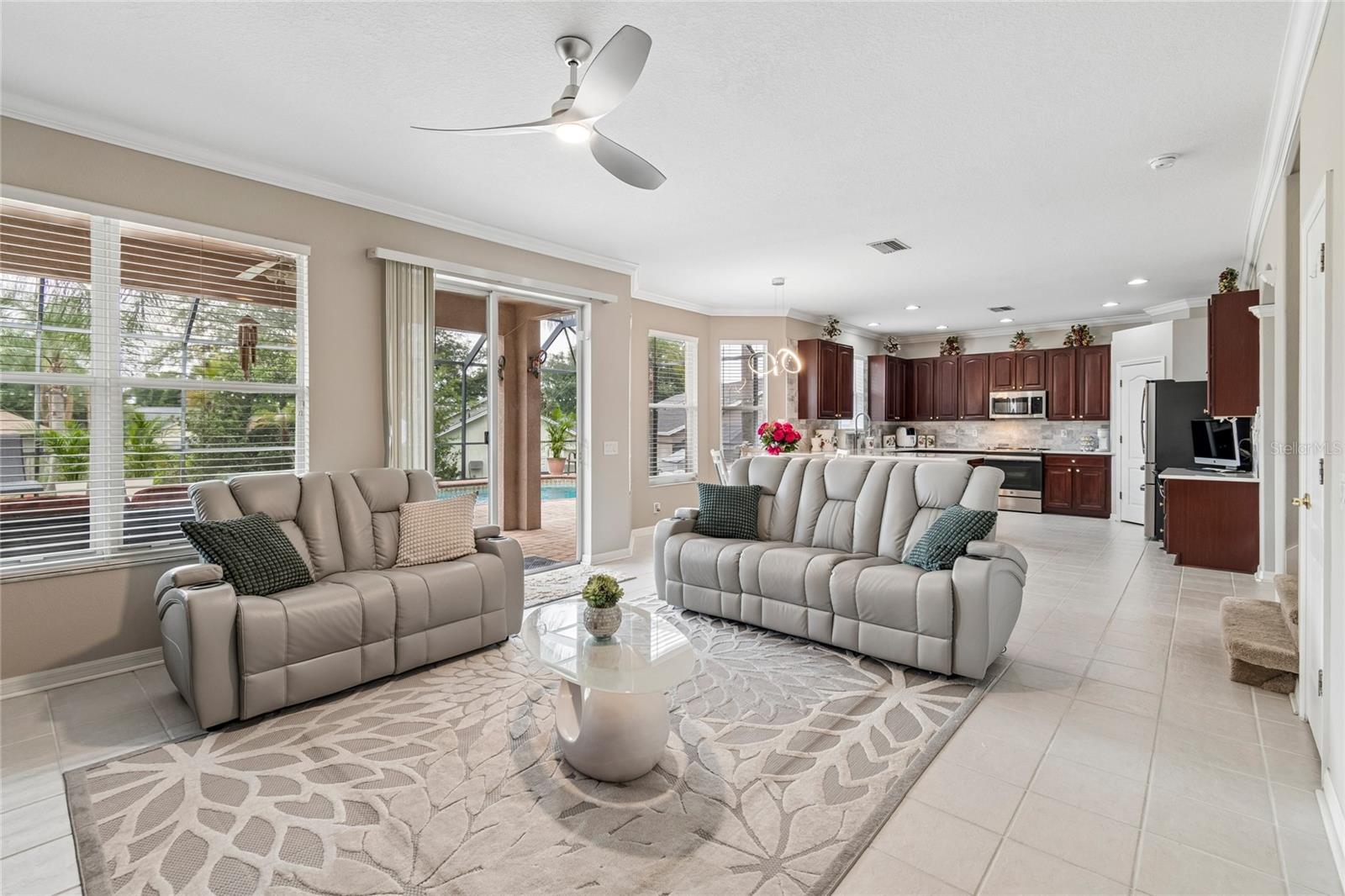 Family Room with Ceiling Fan and crown molding