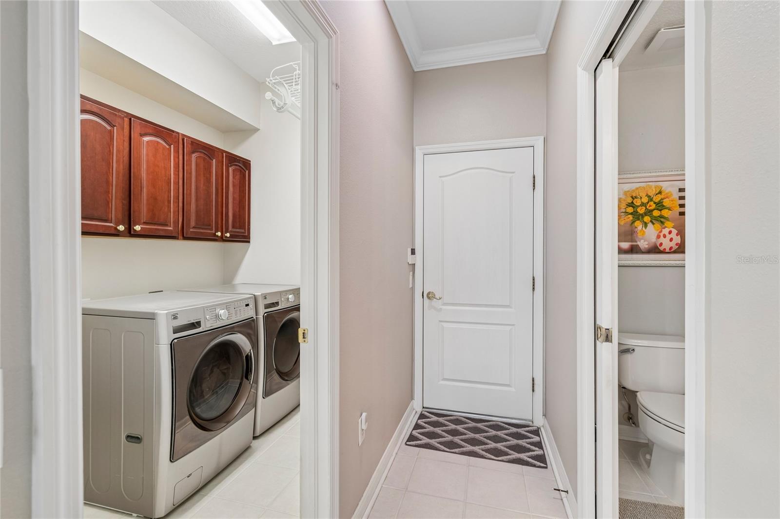 Laundry room equipped with W/D , cabinetry and convenient utility sink