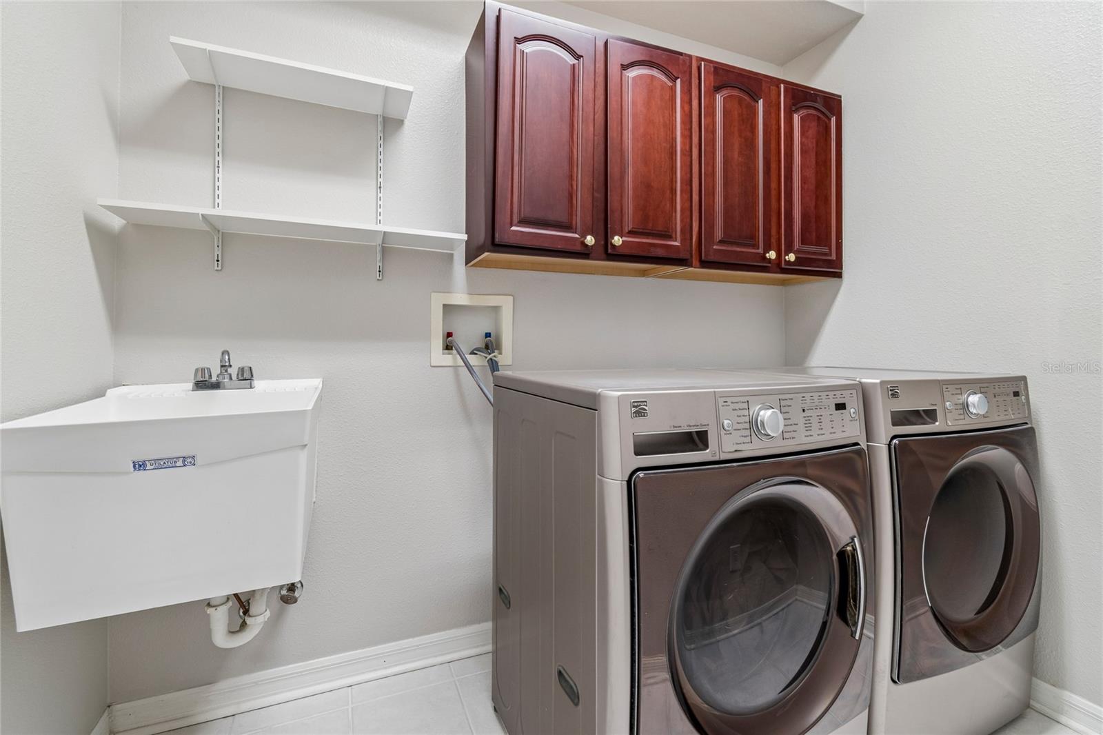Laundry room equipped with W/D , cabinetry and convenient utility sink