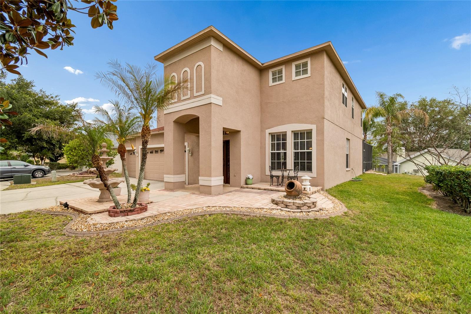 Home is distinguished by the welcoming Courtyard retreat, window trim, 3 tier water fountain, Mature Magnolia Tree and Robellini Palm.