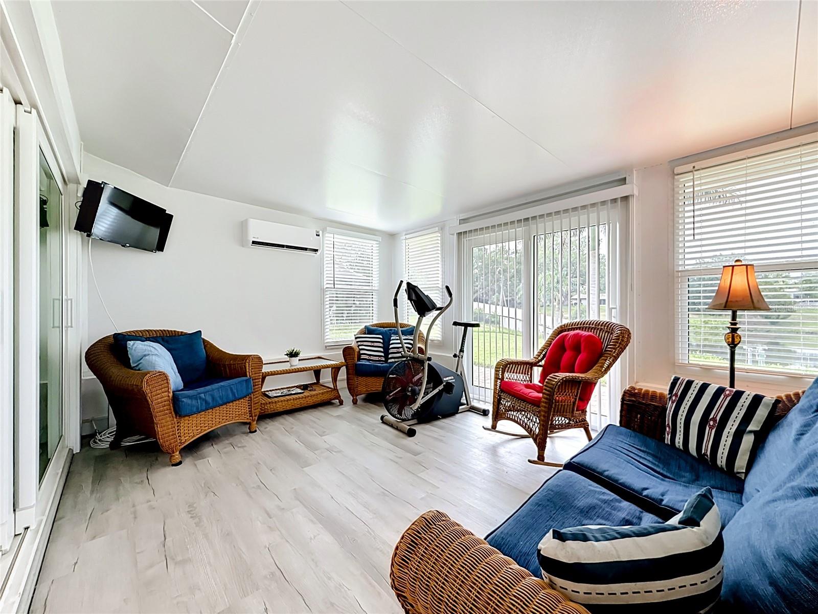 Enclosed Florida room iwth views of the water