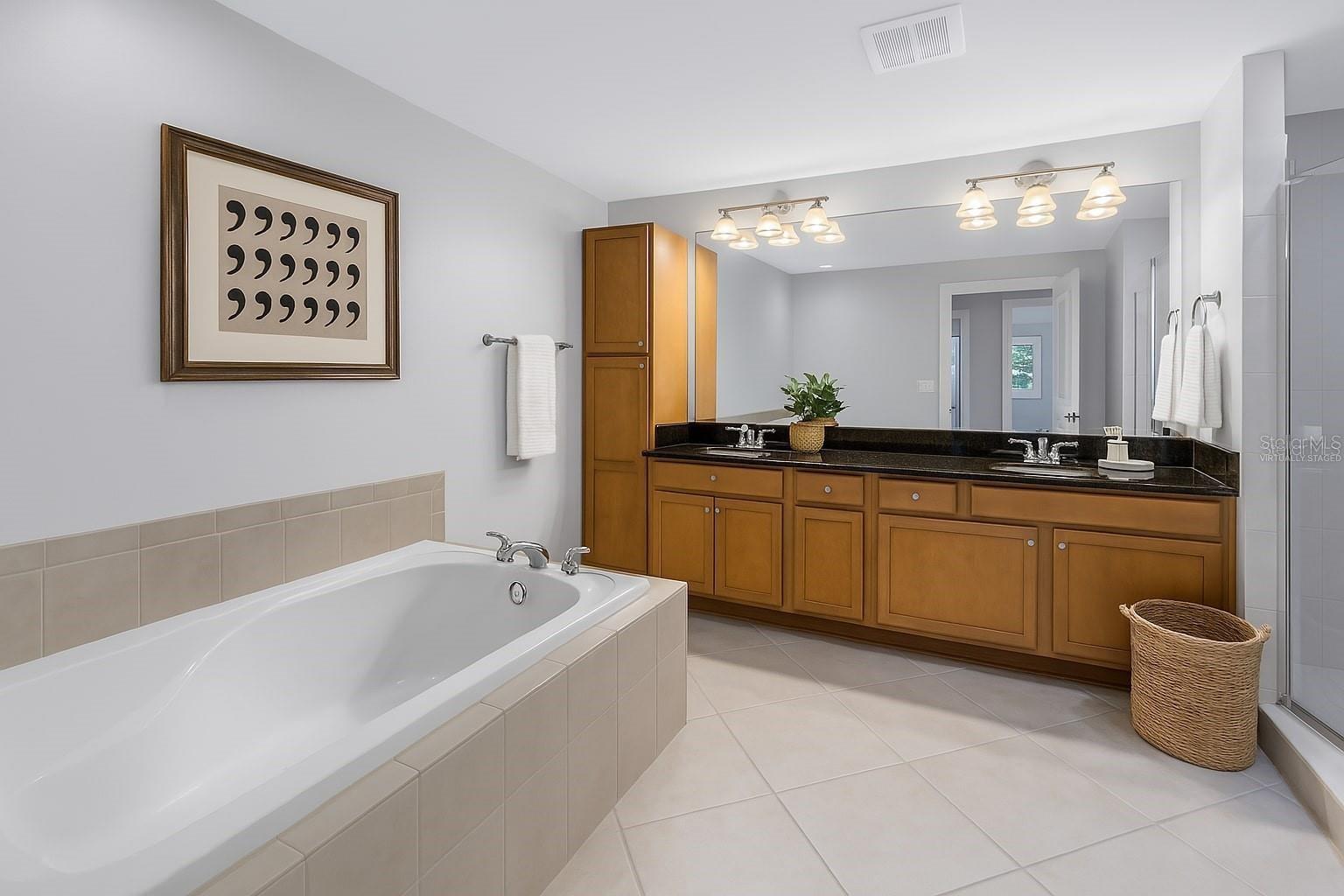 Primary Bathroom Tub and Duel Sink - Virtually Staged
