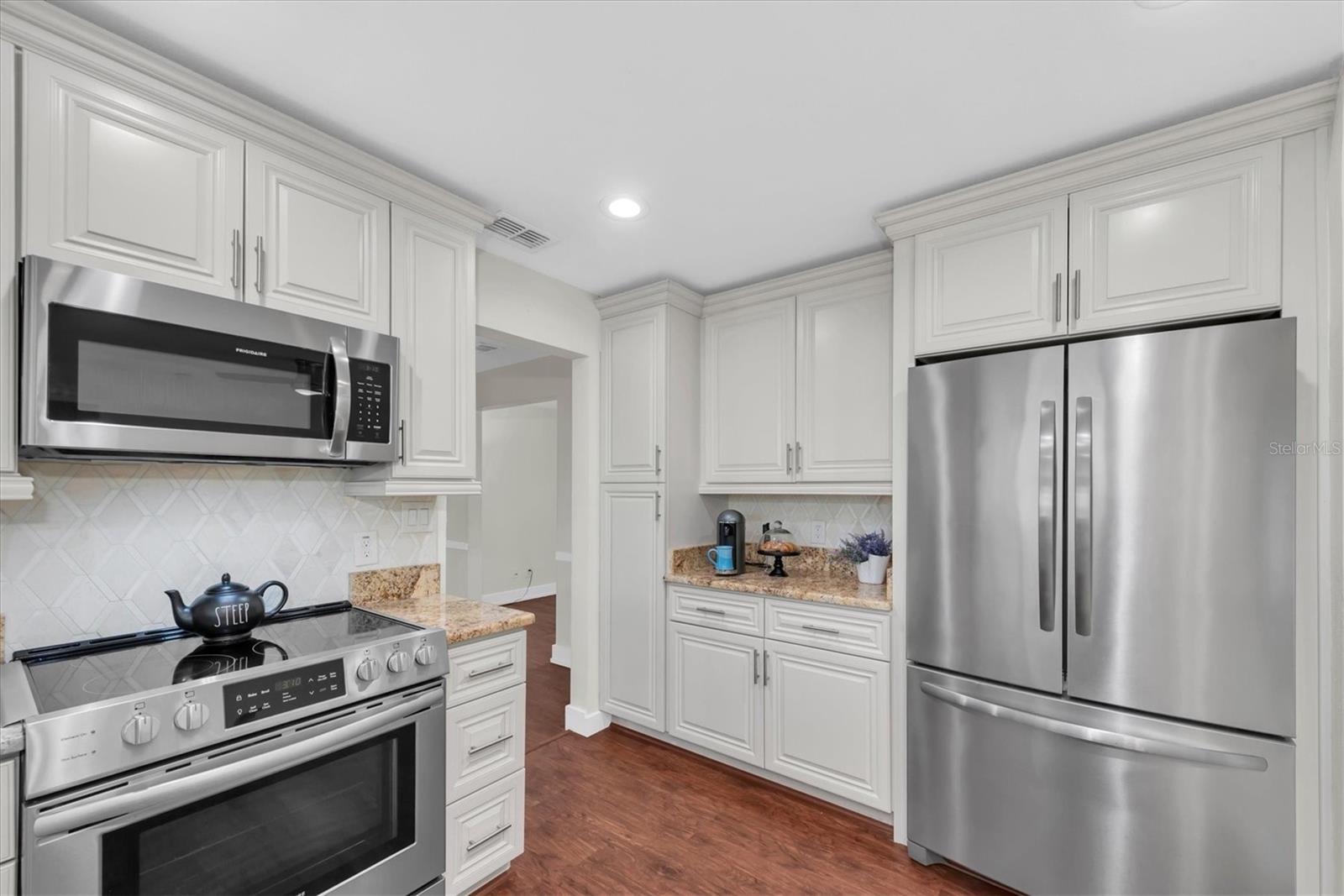 Updated kitchen with granite countertops and stainless steel appliances