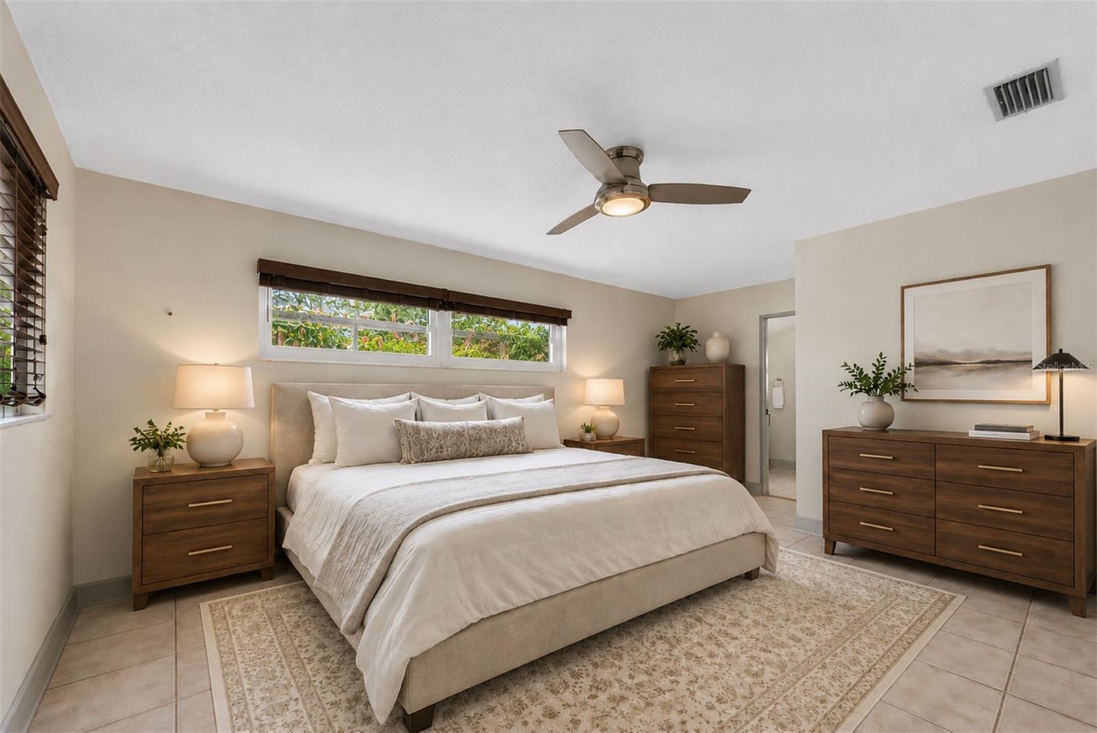 Private primary suite with walk-in closet and updated en-suite bath