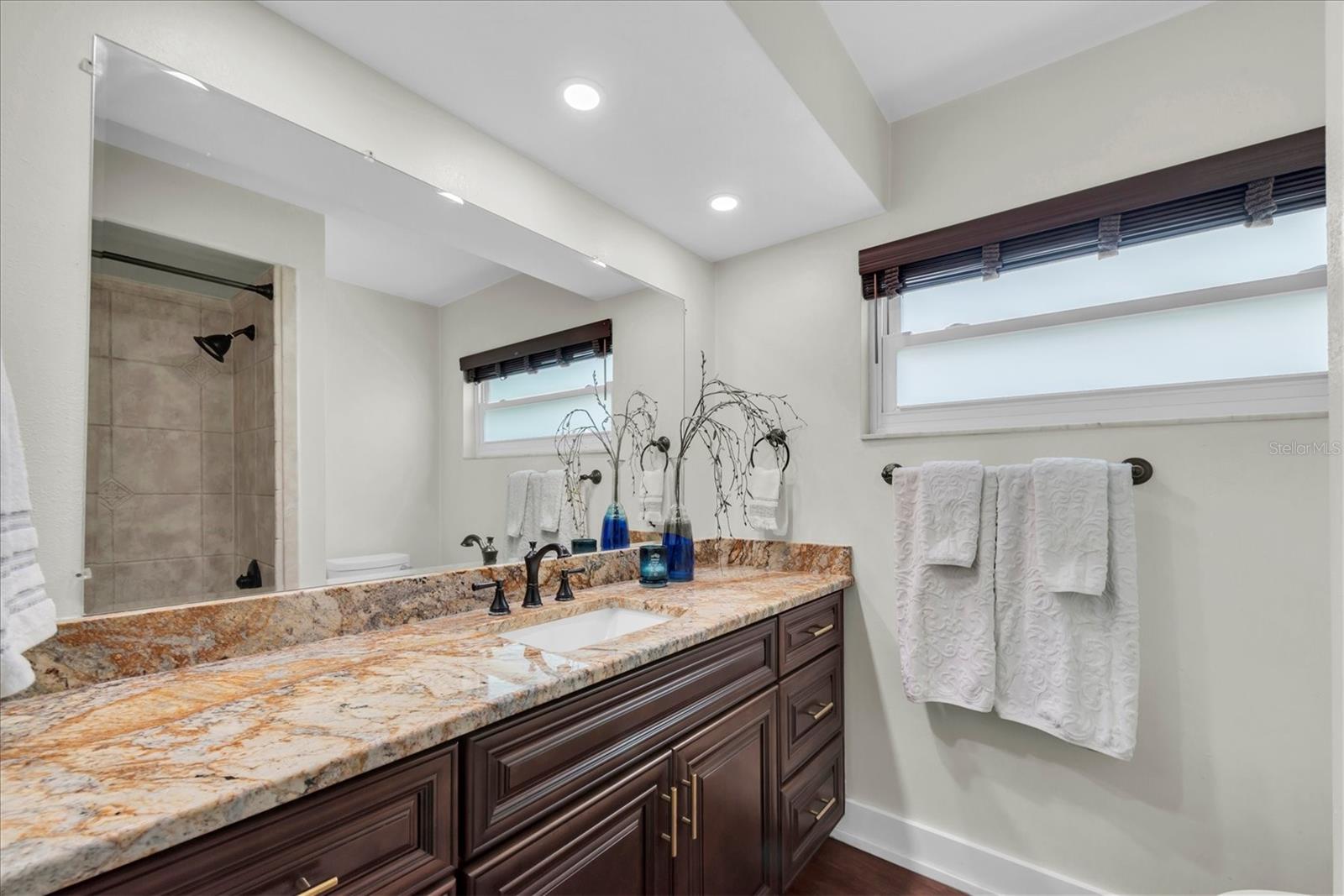 Luxury vinyl plank flooring and tile throughout — no carpet anywhere
