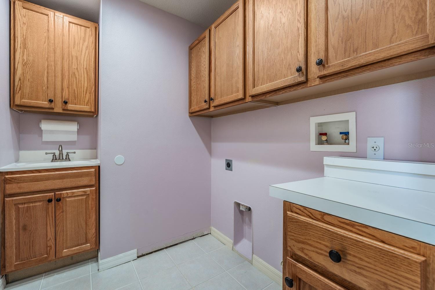 laundry room with cabinets for storage