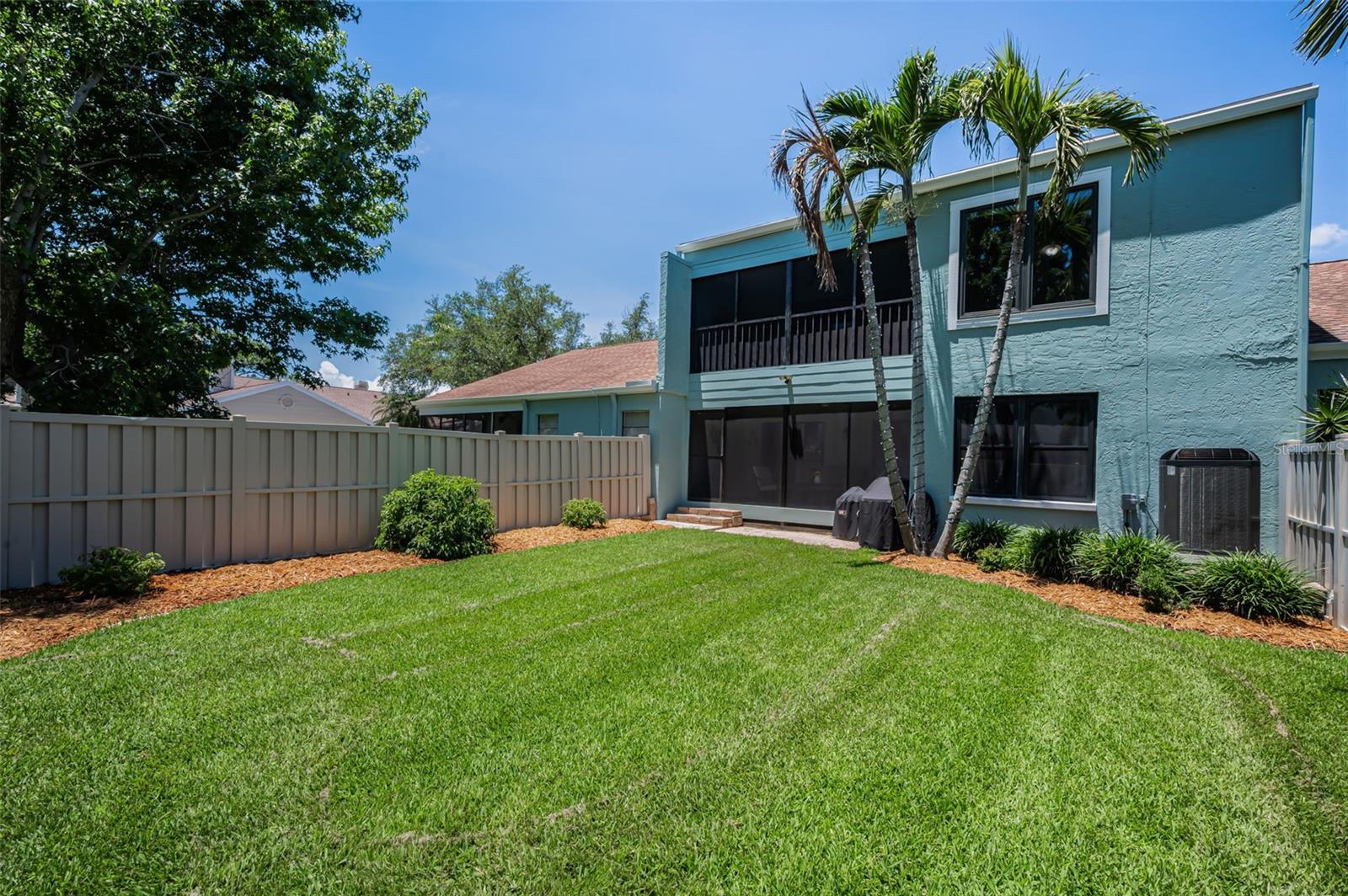 Looking out over the beautifully manicured, fenced private yard — an ideal setting for morning coffee, quiet afternoons, or relaxing evenings at the end of the day.