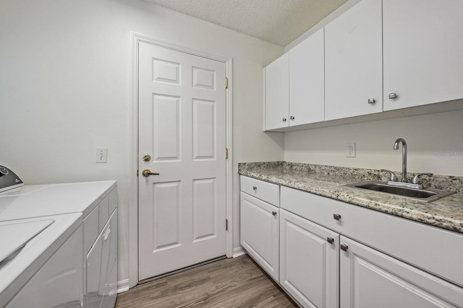 Walk-in laundry room with lots of storage options