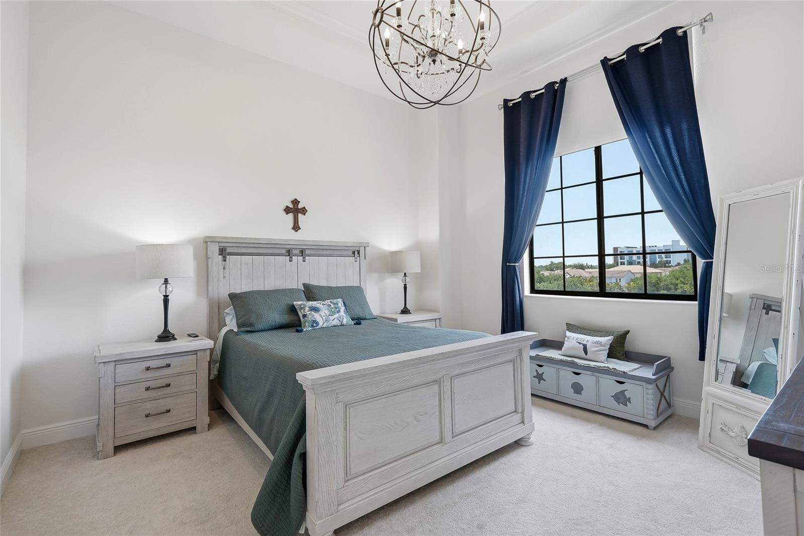 Primary bedroom with 12ft ceilings and a sophisticated chandelier.