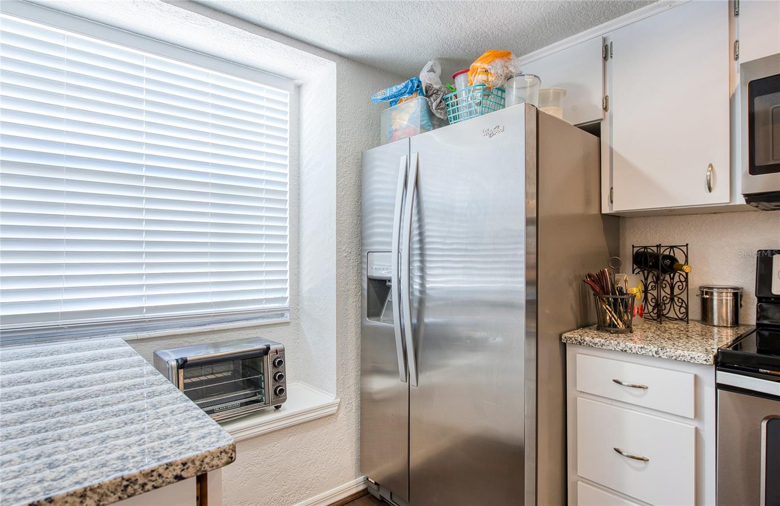 stainless refrigerator with water and ice in the door.