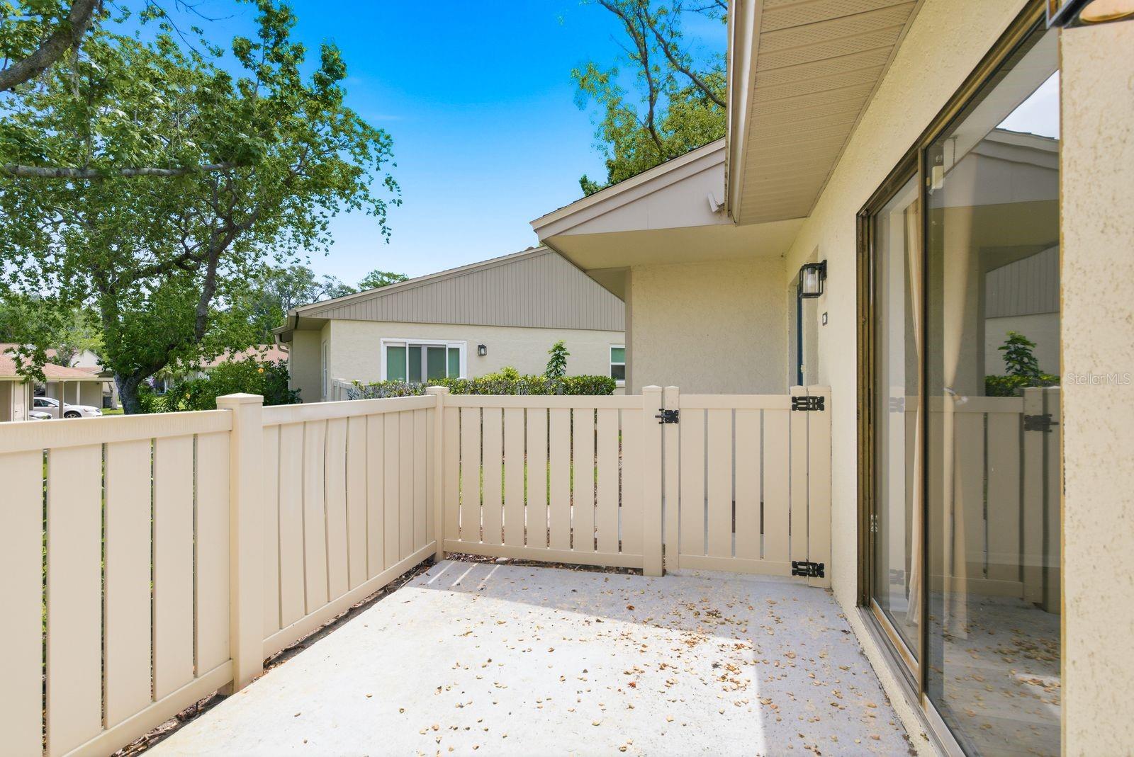 Gated front porch with entry to kitchen and living areas.