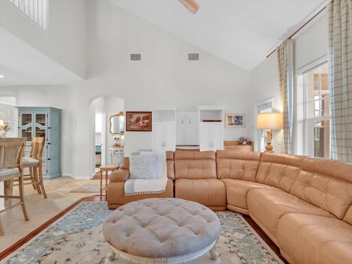 Family room with hardwood floors, Built in Storage and shoe rack cabinet both attached to the back door wall area Do Convey with the home.