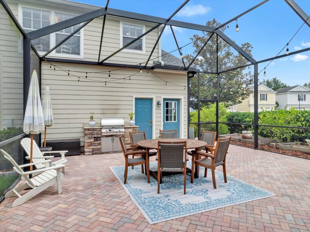 Screened patio with a Built in Gas Grill and  a Brick Herringbone patterned Patio about 500 sq feet of outdoor living space to enjoy! Door to the 3 car garage and the Upstairs 1bed/1Bath with full kitchen ADU.