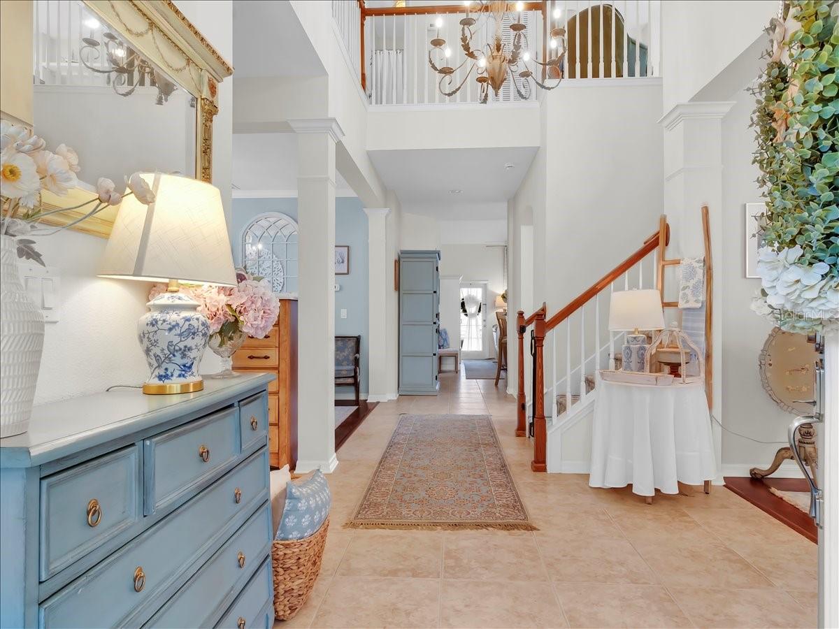 Foyer with elevated ceilings, welcoming dining room to your right.