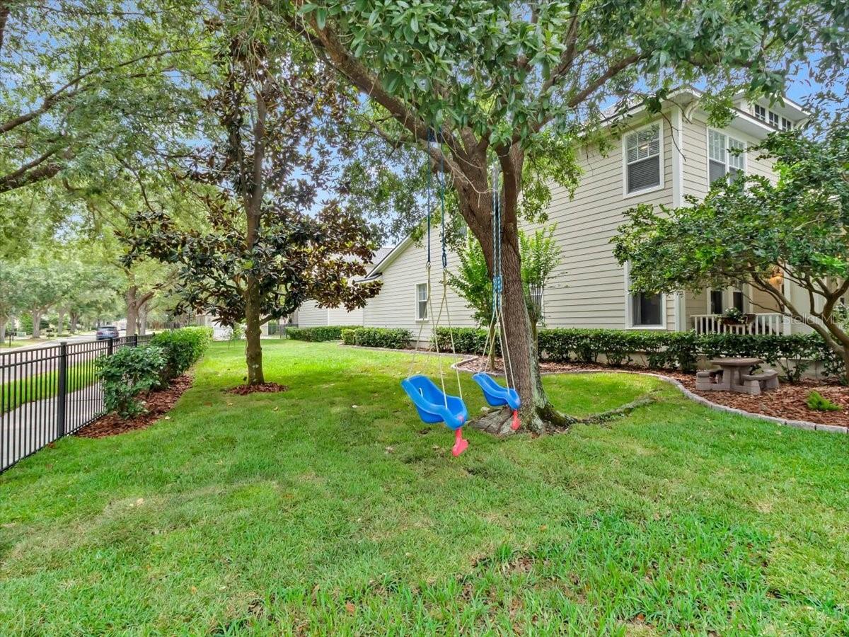 Beautiful Rose Granite Landscape Stone Curbing lines the flower beds keeping everything Neat and Tidy next to the NEWLY LAID SOD!! Fenced entire yard with Black Aluminum Fencing. Side yard offers plenty of room to PLAY!
