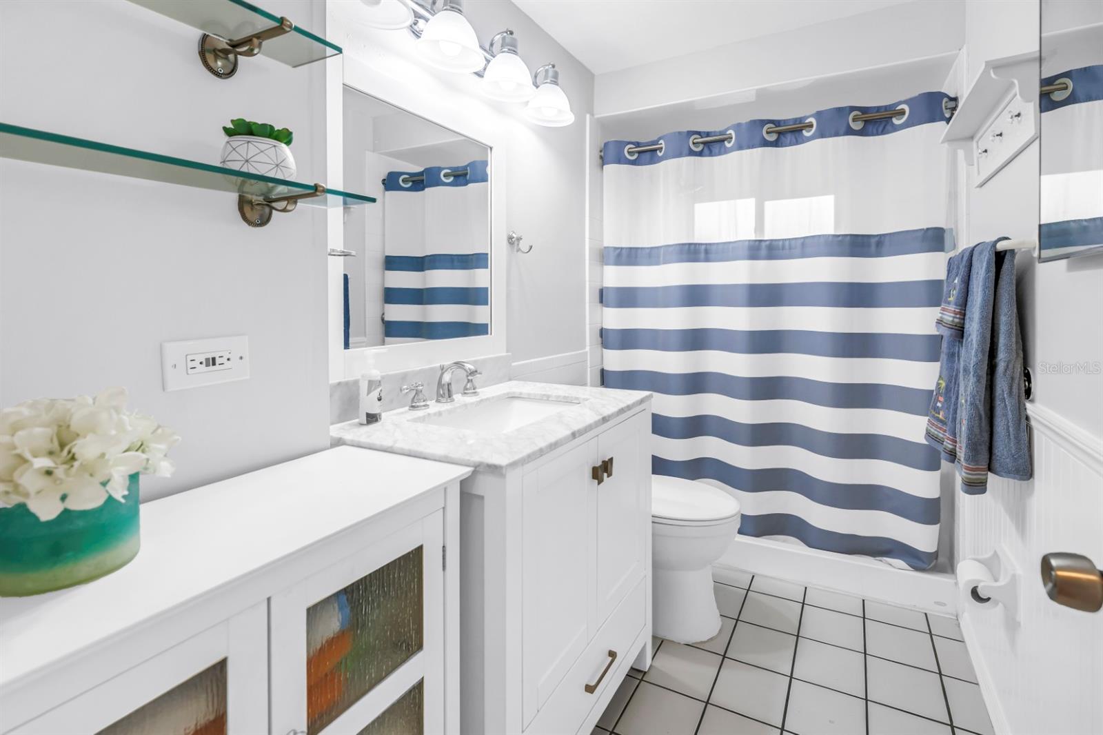 Bathroom features updated vanity and accessible walk-in shower