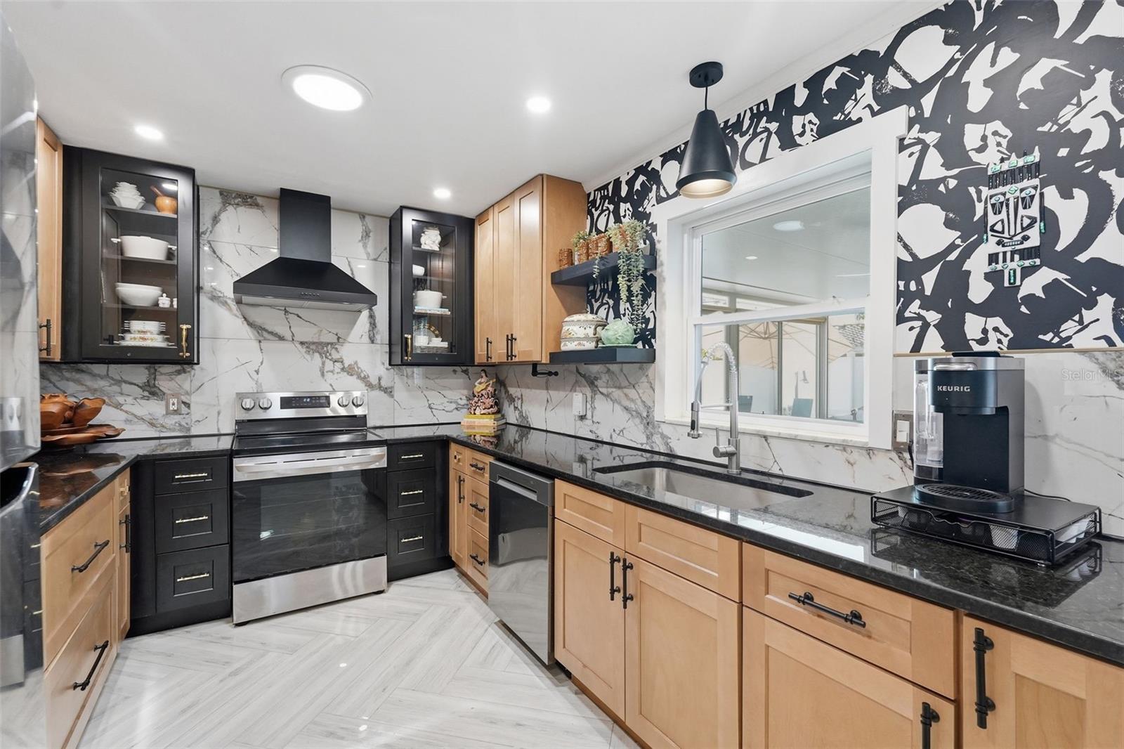 A dramatic marble-look feature wall steals the show in this bold, designer-inspired kitchen.