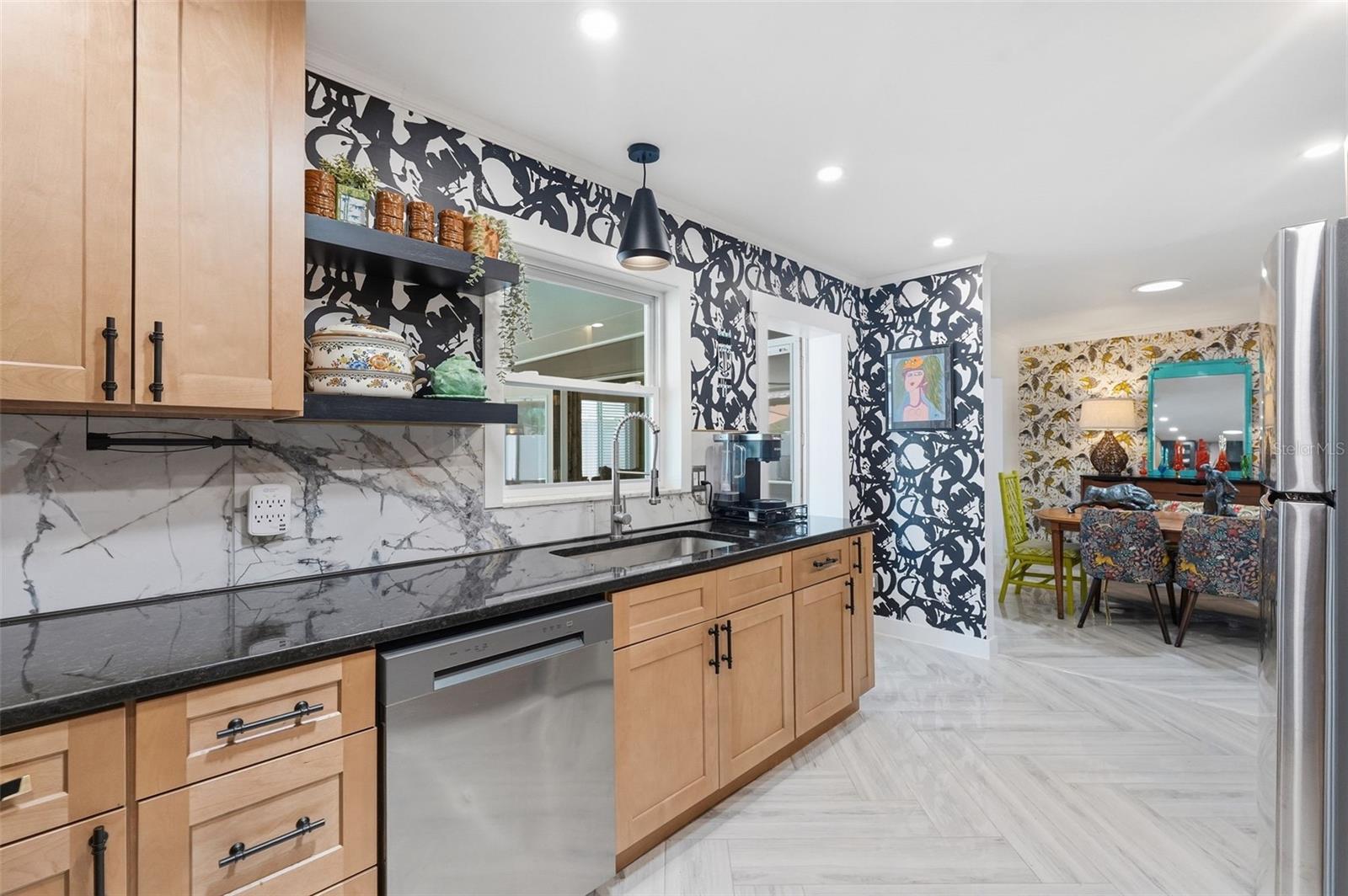 A dramatic marble-look feature wall steals the show in this bold, designer-inspired kitchen.