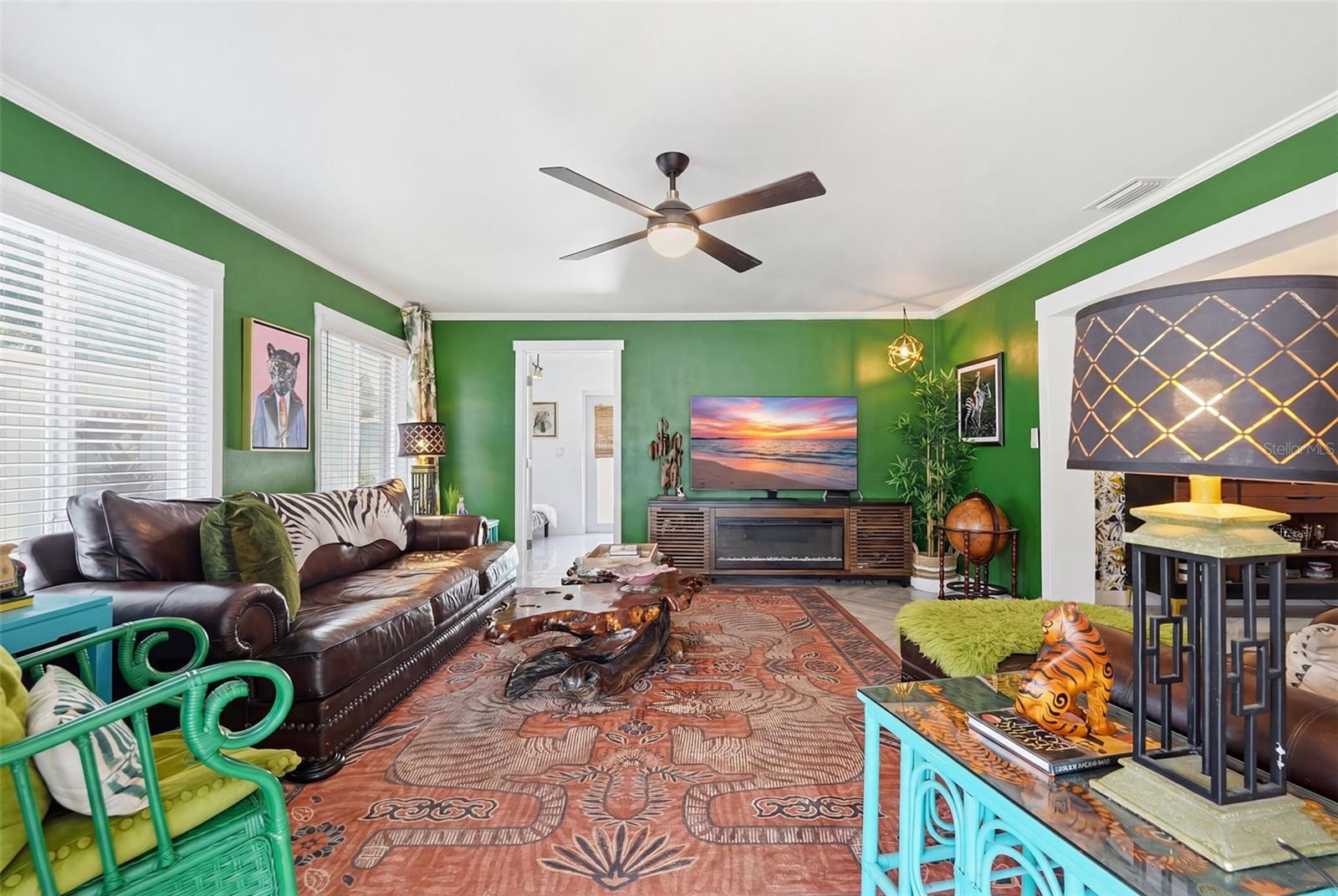 A nod to Elvis’ iconic Jungle Room, this moody lounge layers rich color, bold personality, and vintage-inspired flair.