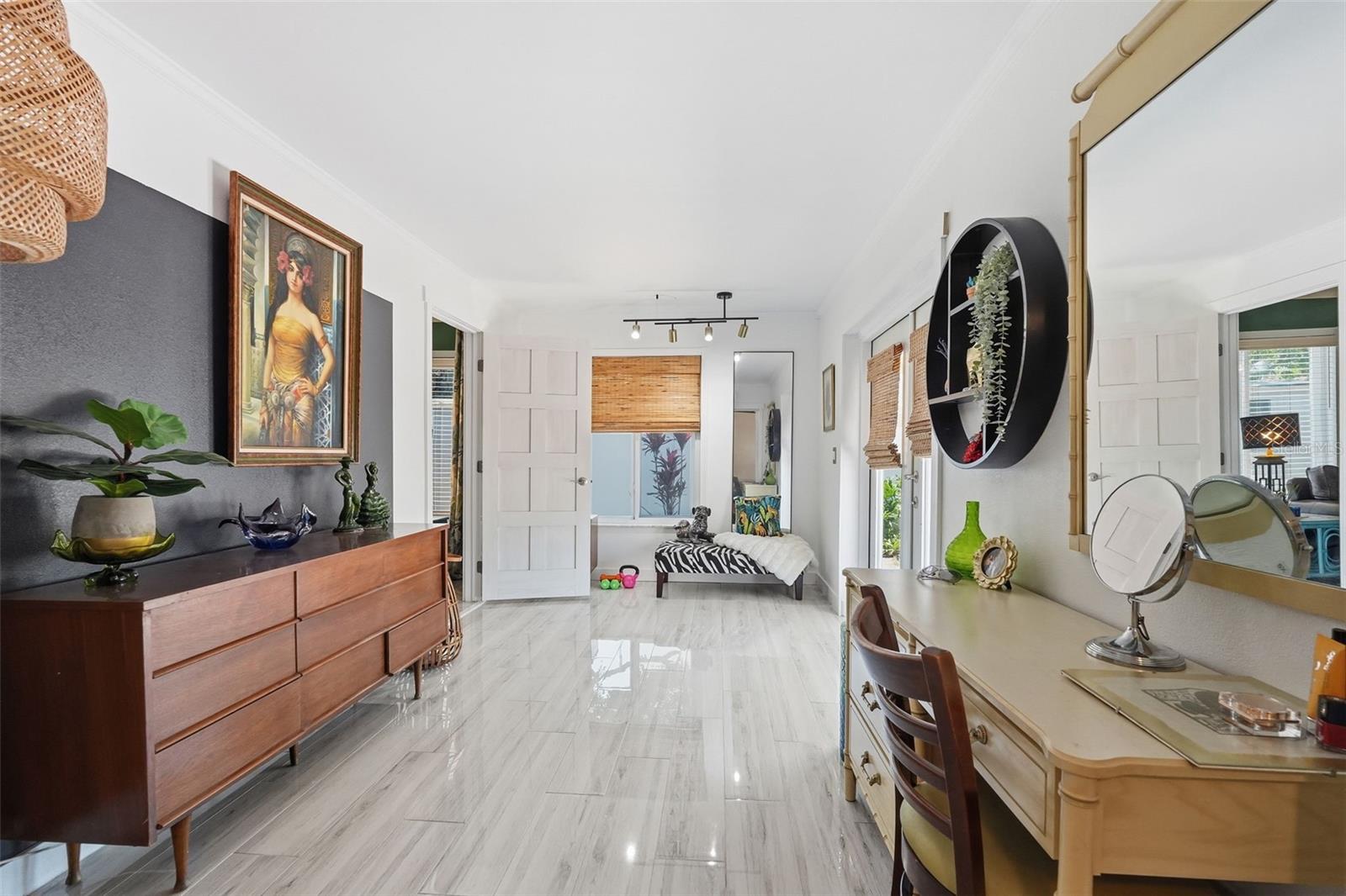 The oversized owner’s suite features an en suite bath, walk-in cedar closet, and expanded flex space perfect for a lounge, office, dressing room, or private retreat.