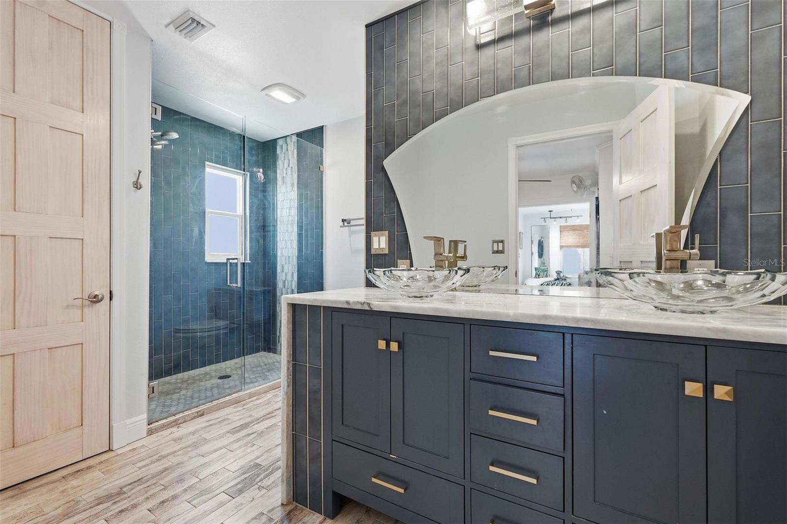 The oversized owner’s suite features an en suite bath, walk-in cedar closet, and expanded flex space perfect for a lounge, office, dressing room, or private retreat.