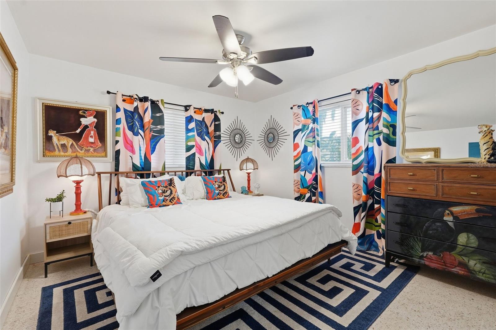 Two sizable guest bedrooms and a full bathroom are tucked away on the opposite side of the home for added privacy.