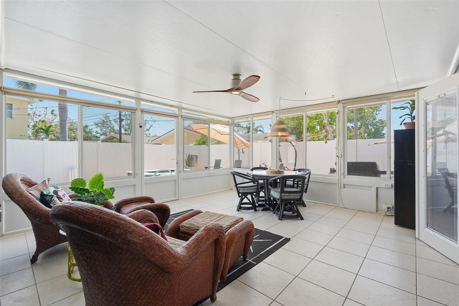 The screened patio offers the perfect bonus hangout space with sliding windows, room to lounge or dine, and even a mini fridge for easy entertaining.